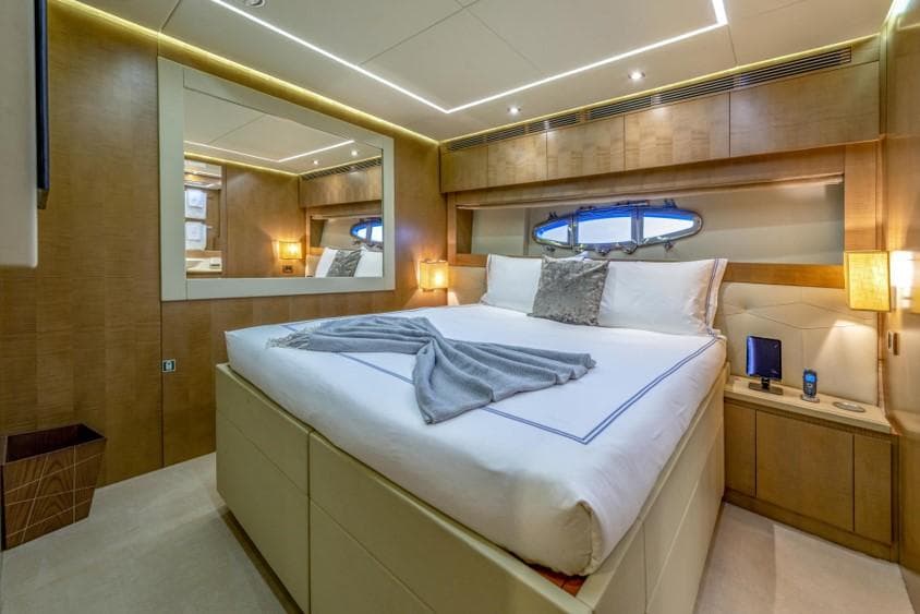 Luxurious bedroom interior on 2013 Pershing 108 yacht with modern design and elegant lighting.