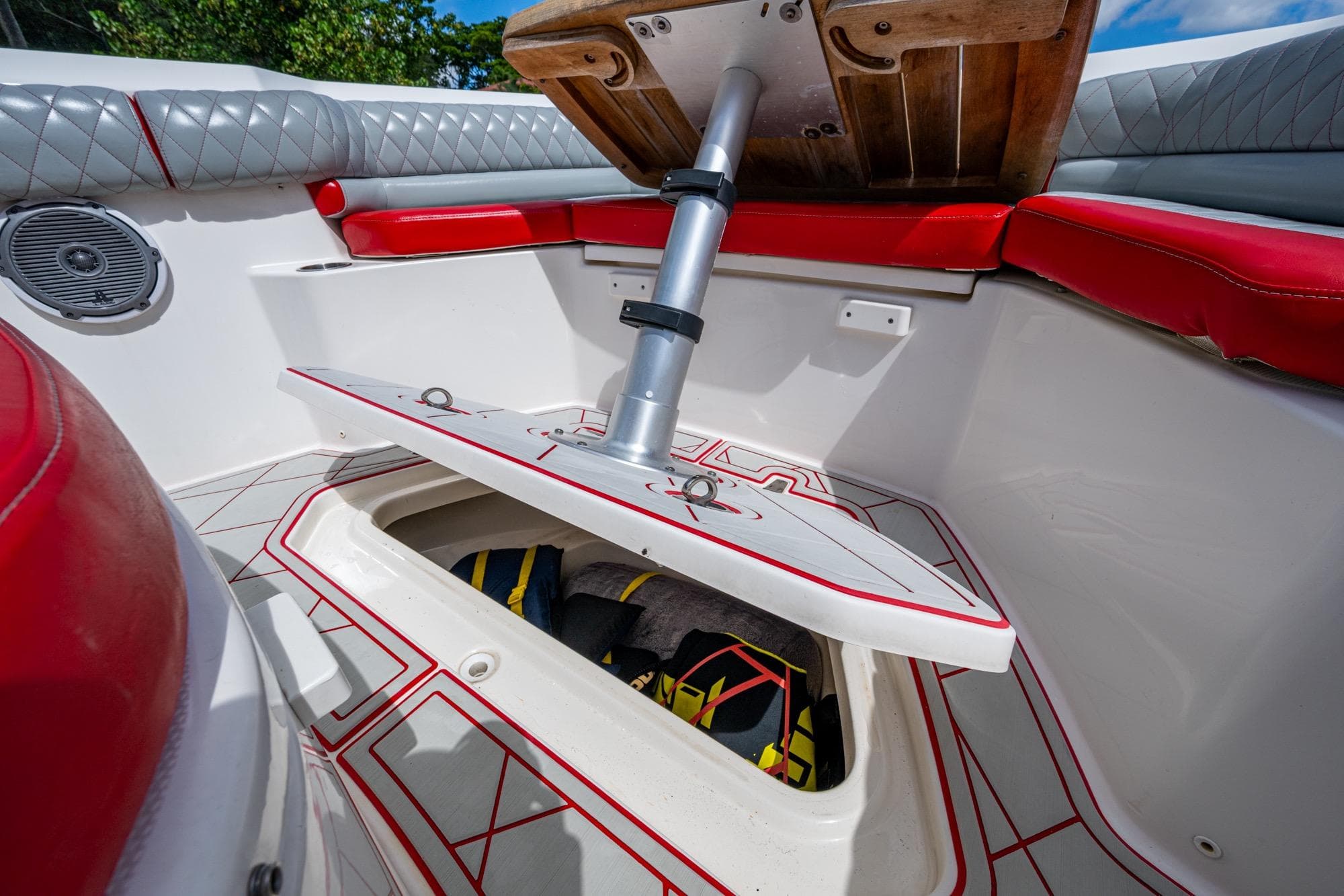 2018 Boston Whaler 330 boat interior with red seating and open storage compartment.