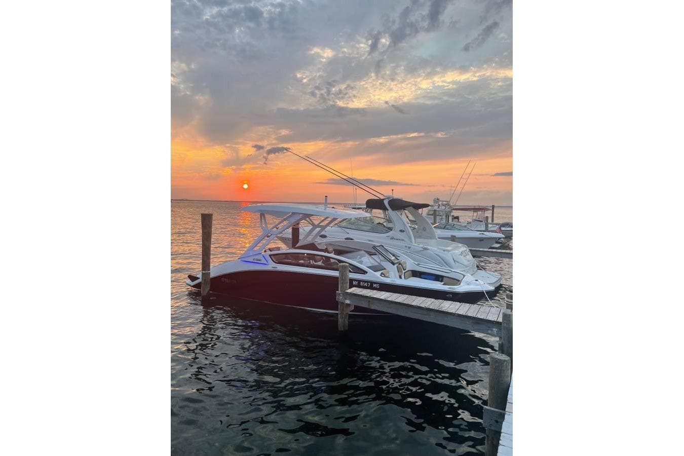 2021 Yamaha Boats 275SD docked at sunset, serene waterfront view.