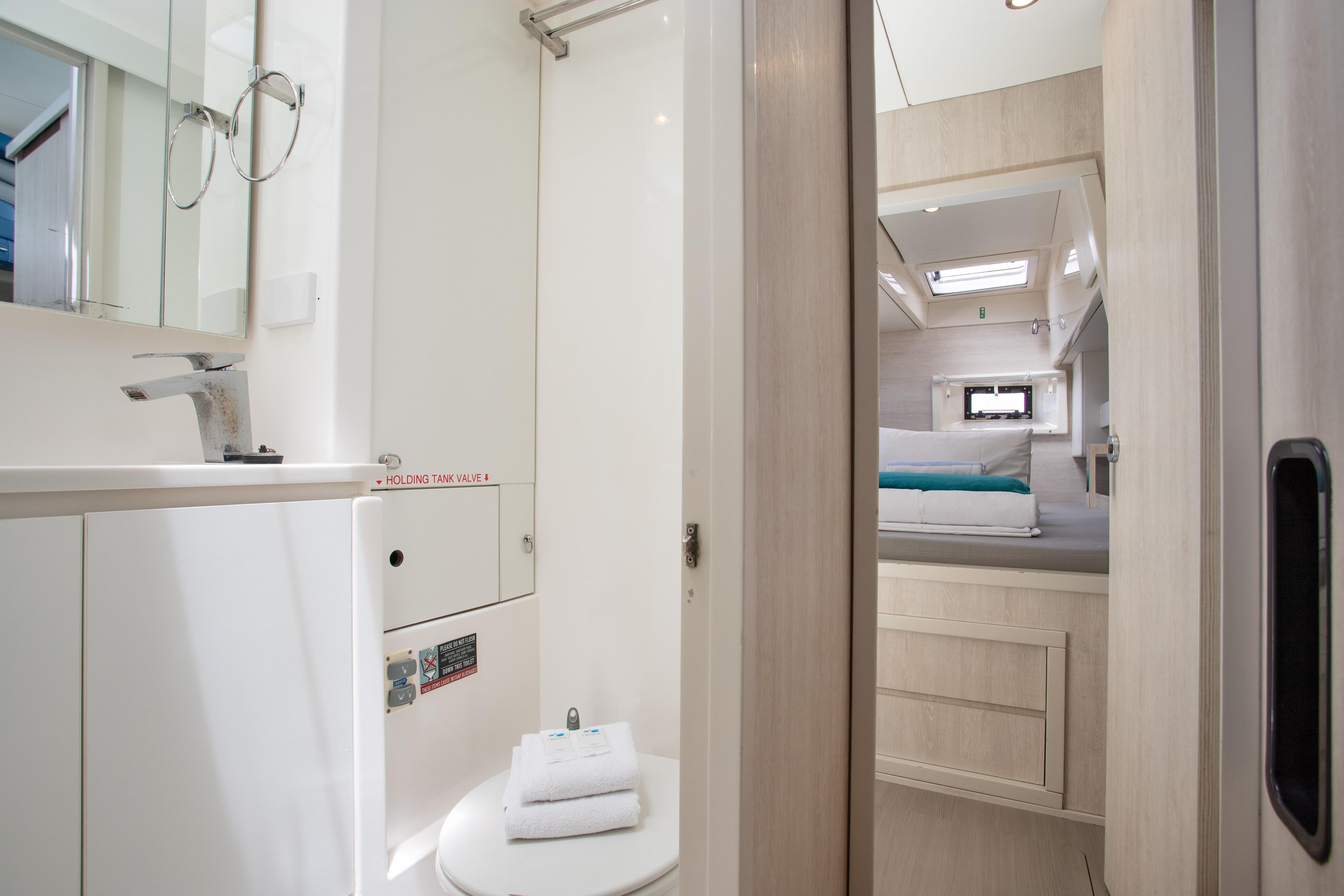 Modern bathroom and bedroom interior of a 2016 Leopard 40 catamaran yacht.