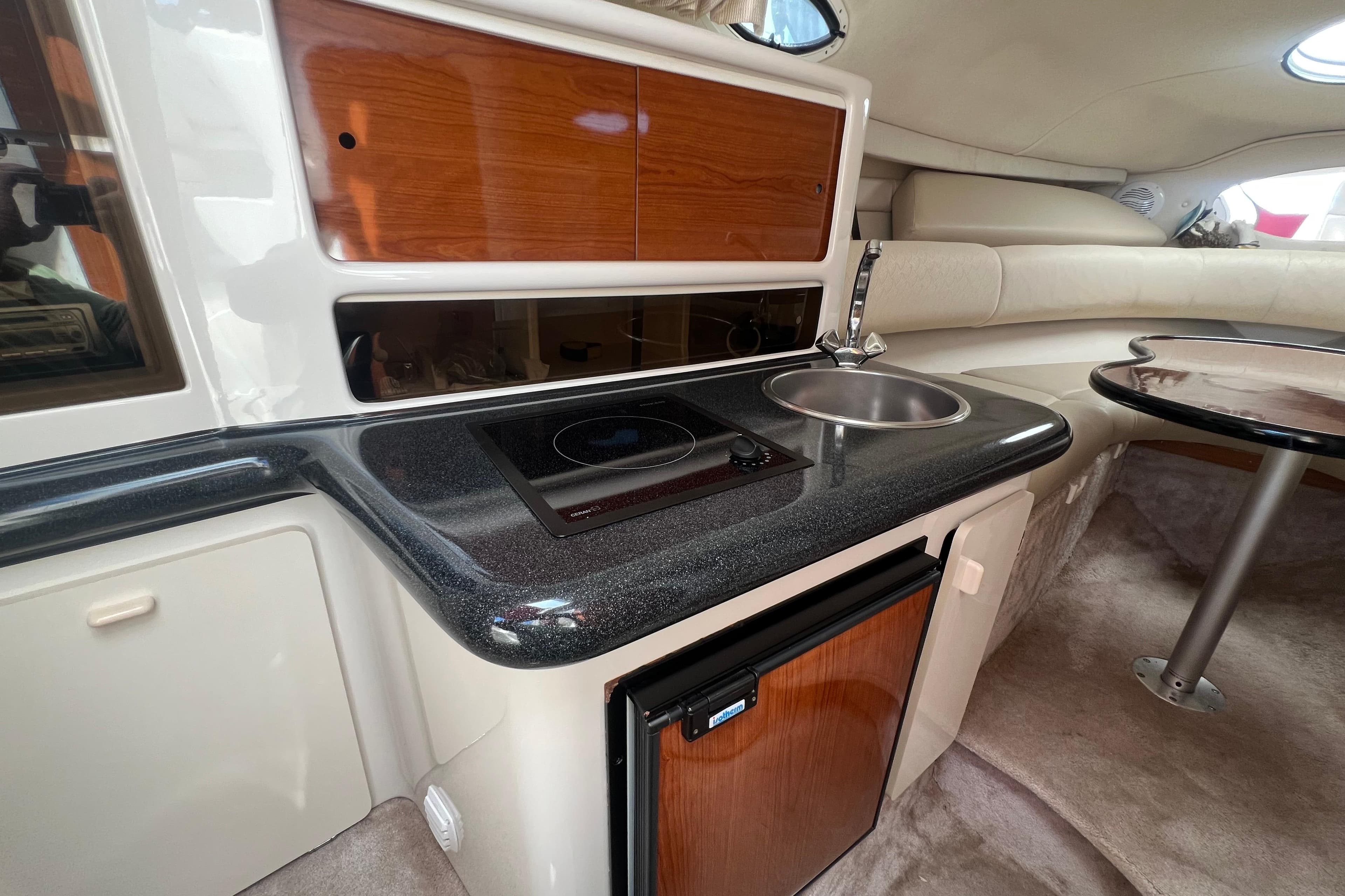 Interior of 2002 Monterey 262 Cruiser with kitchenette and seating area.