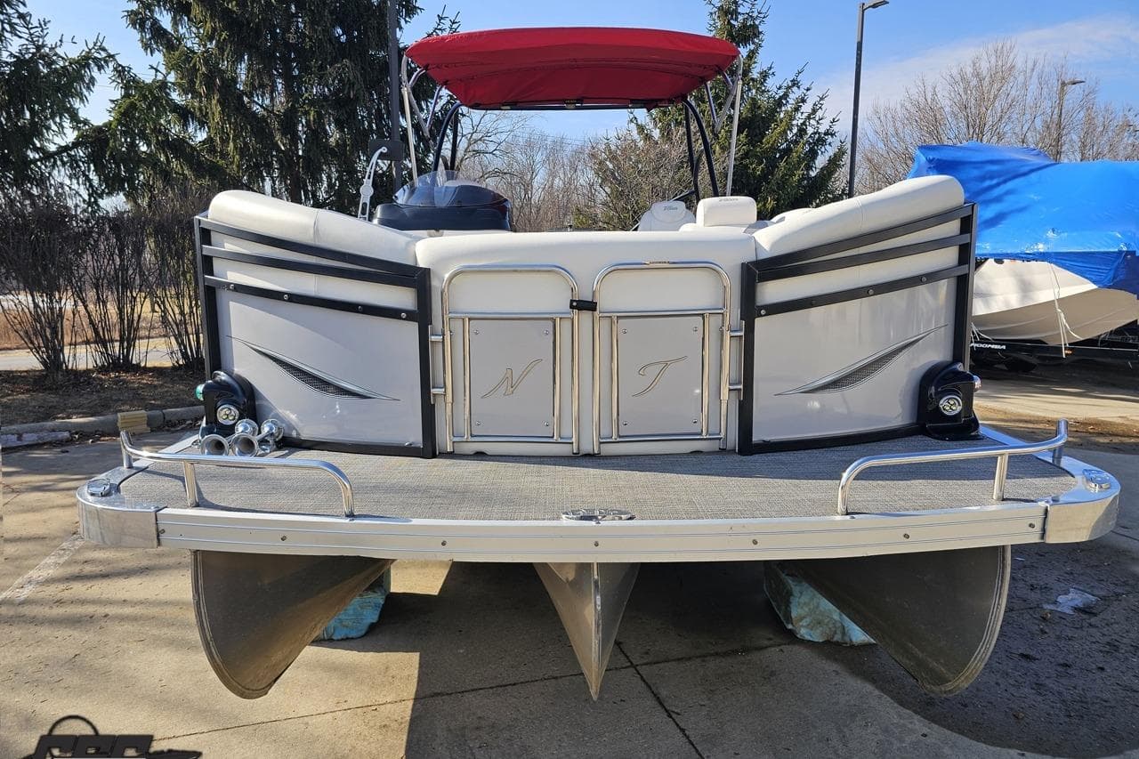 2019 JC Tritoon Neptoon 25 Sport SL pontoon boat with red canopy, docked outdoors.
