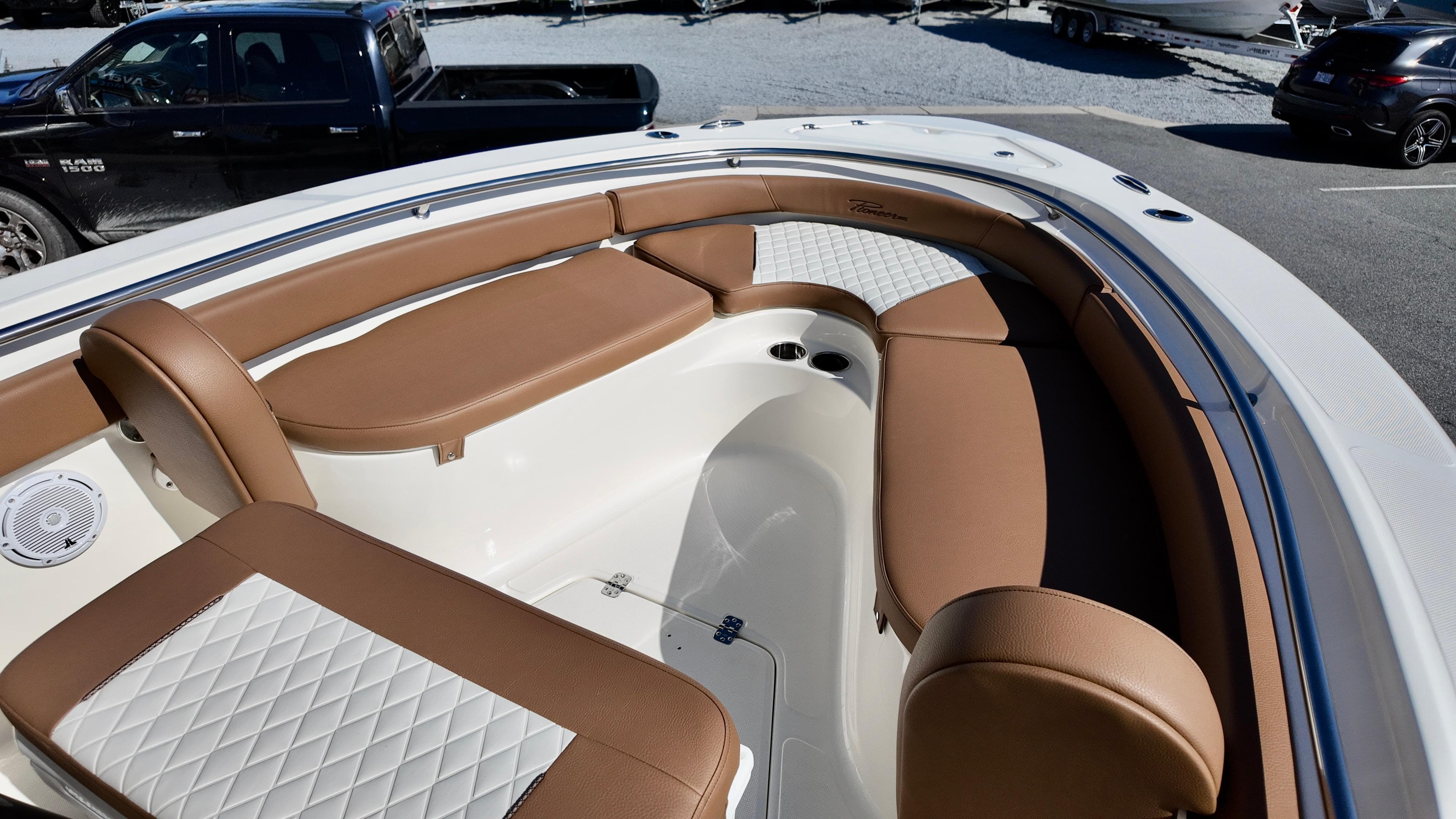 2025 Pioneer 222 Islander boat interior with brown and white seating.