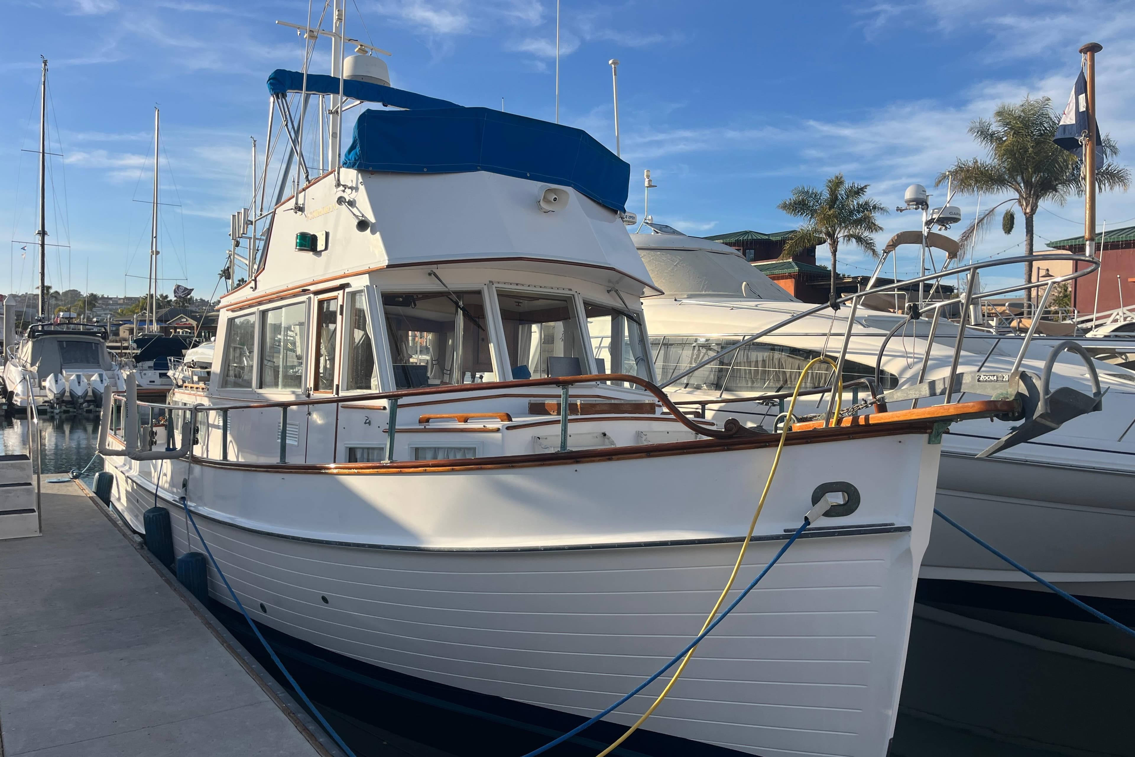 1979 Grand Banks 36 Classic yacht docked at marina under clear blue sky.