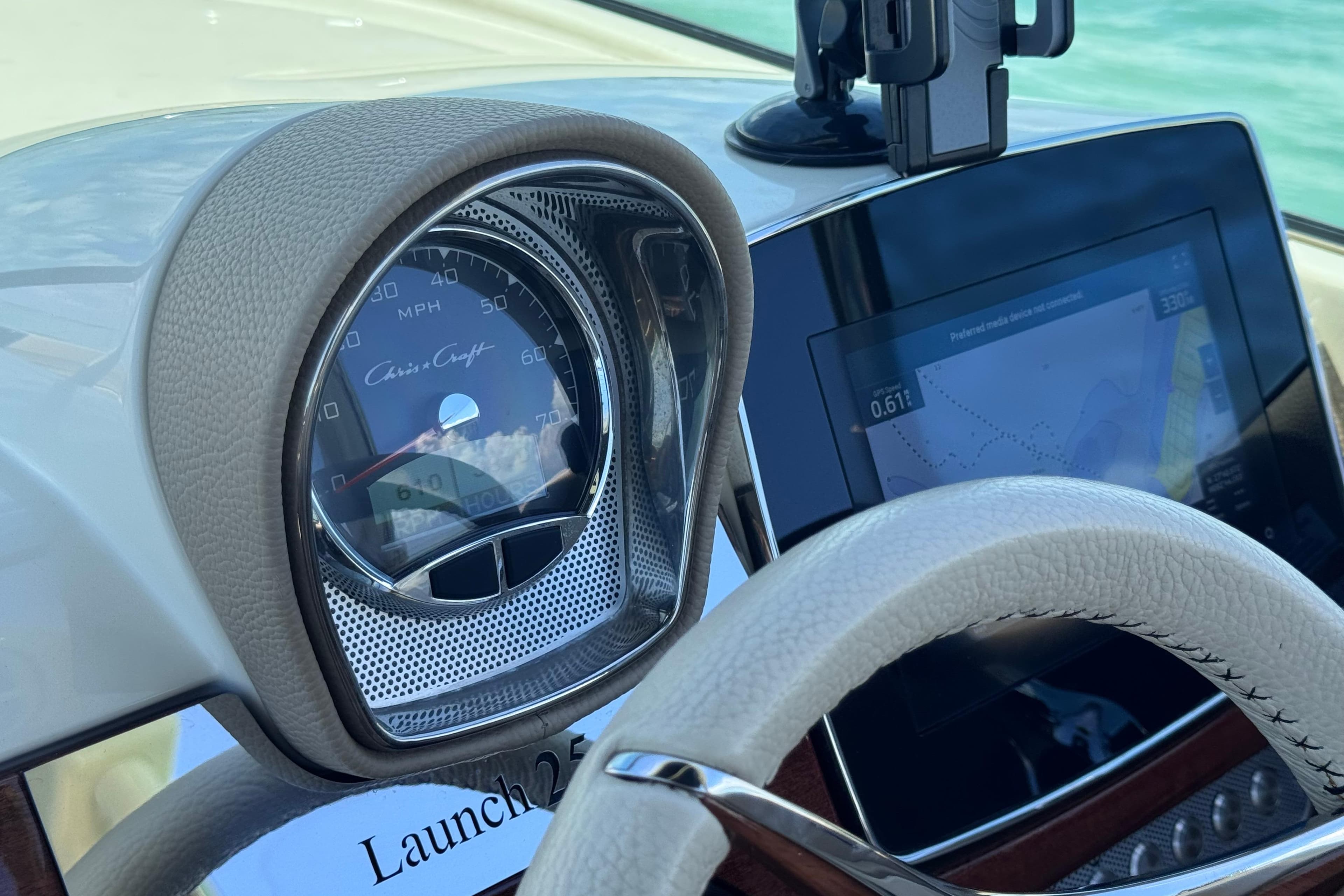 Dashboard of 2023 Chris-Craft Launch 25 GT with speedometer and navigation display.