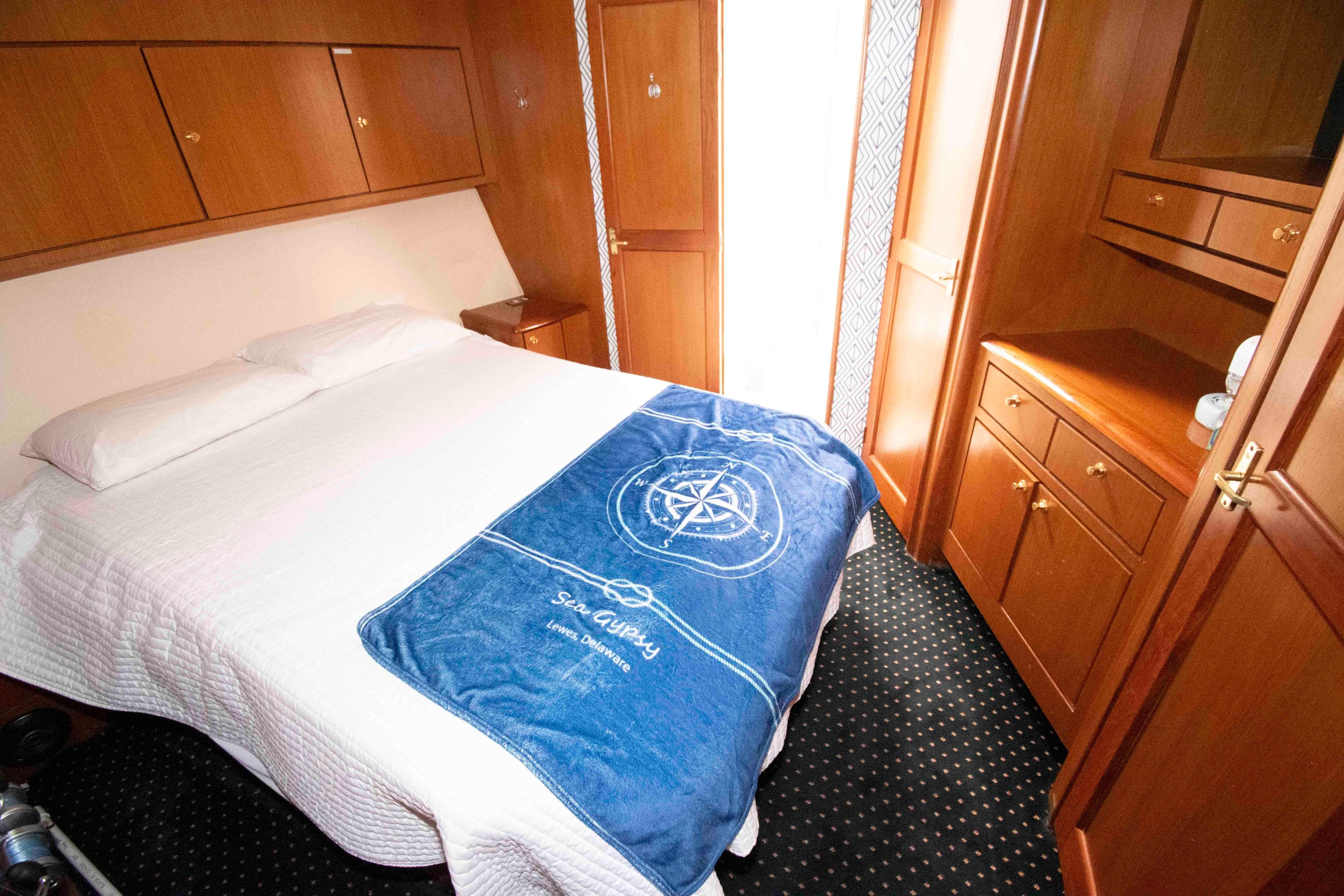 Luxurious cabin interior of 1999 Ocean Yachts 60 Super Sport with cozy bedding.