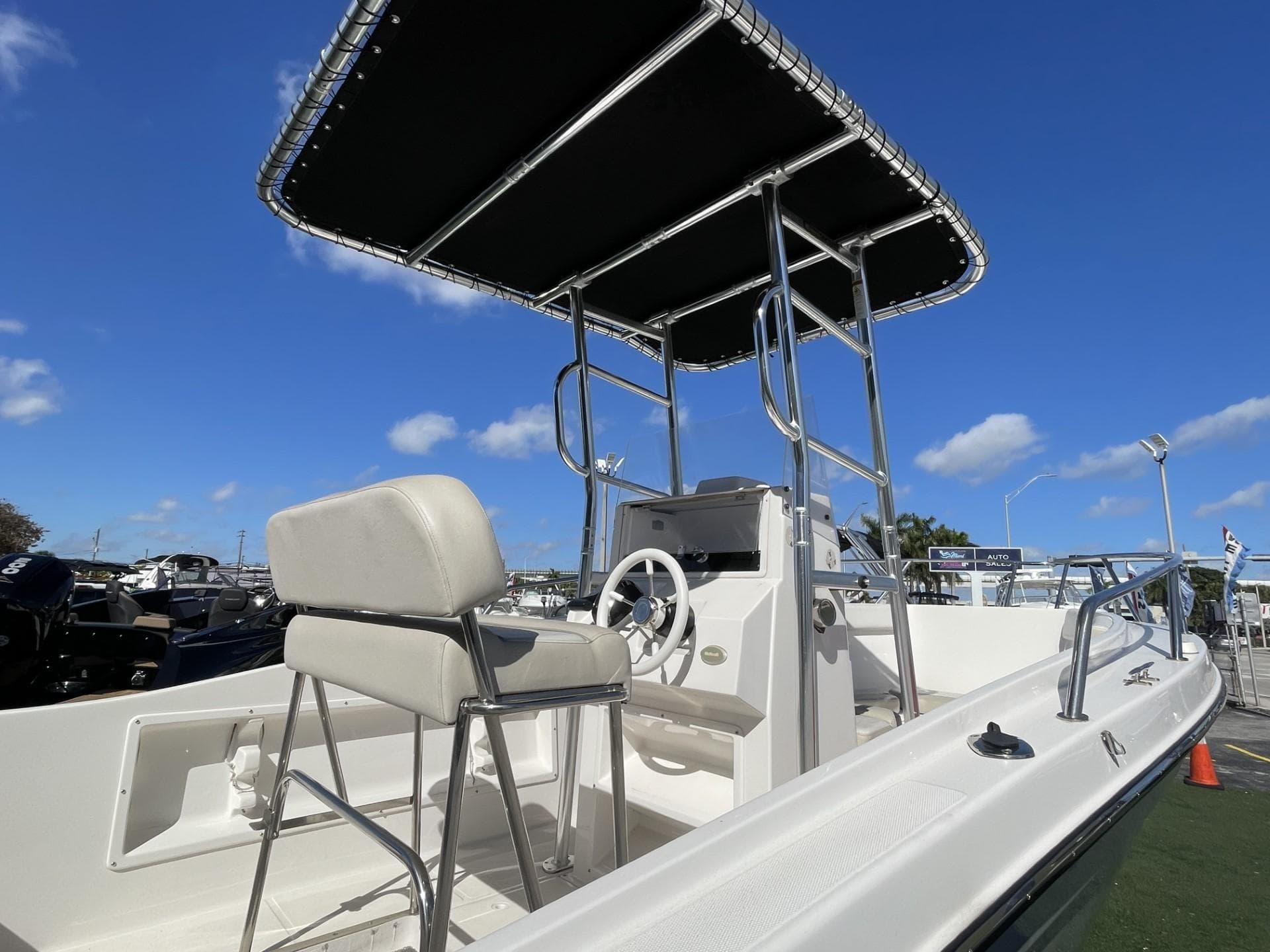 2022 Wellcraft 220CC center console boat with T-top and helm station.
