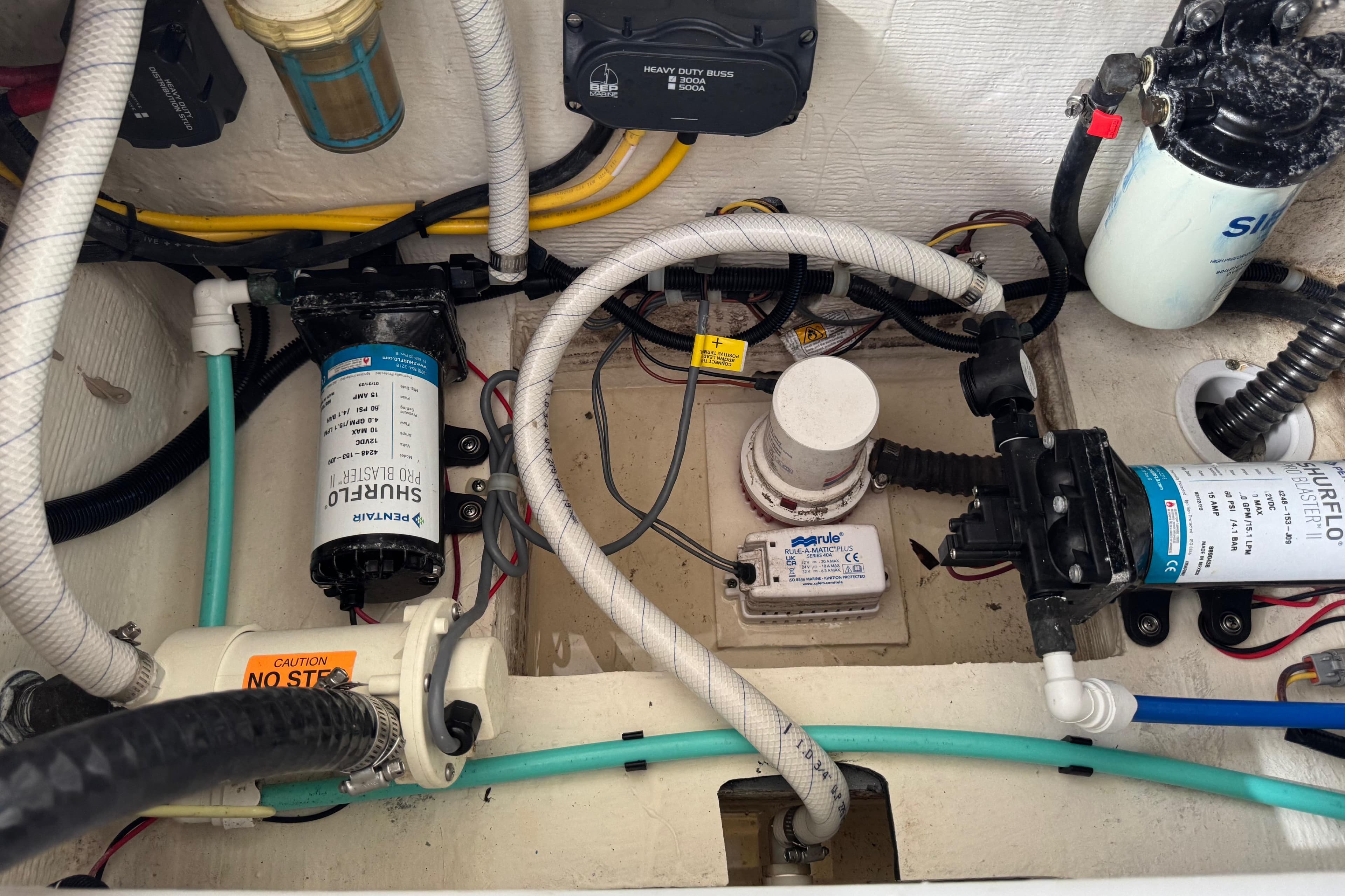 Engine compartment of 2023 World Cat 280 DC-X with pumps and wiring.