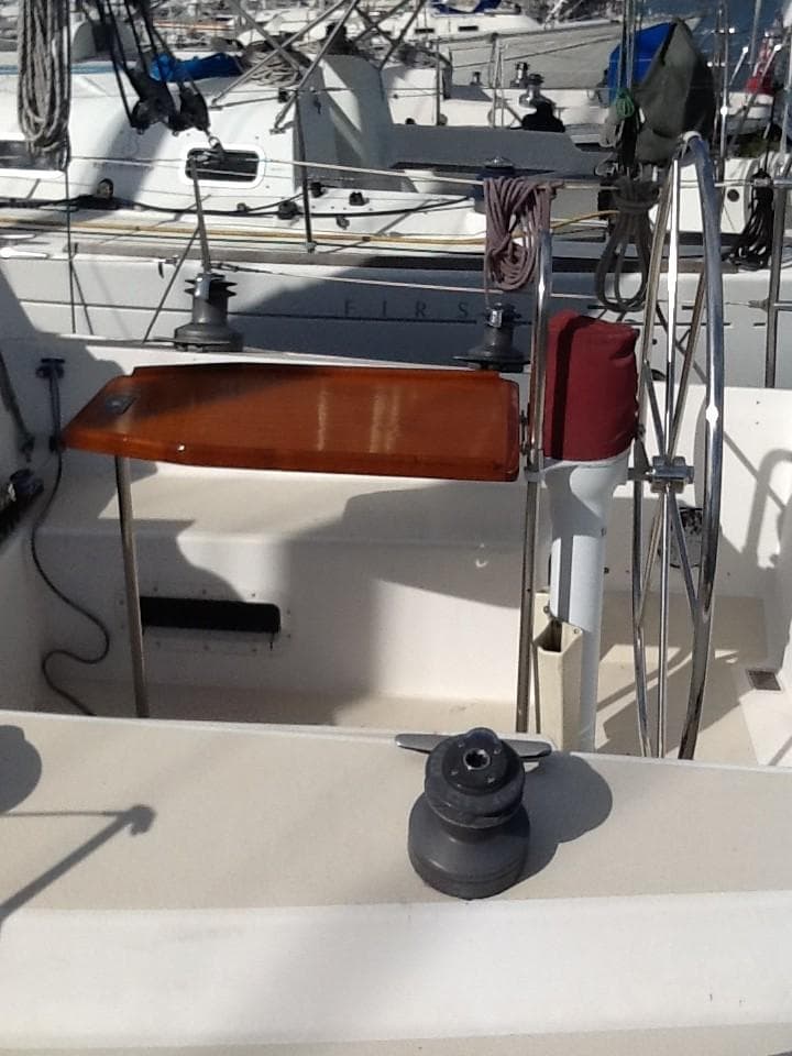 1984 Nelson Marek Morgan 36R sailboat cockpit with winches and wooden table.