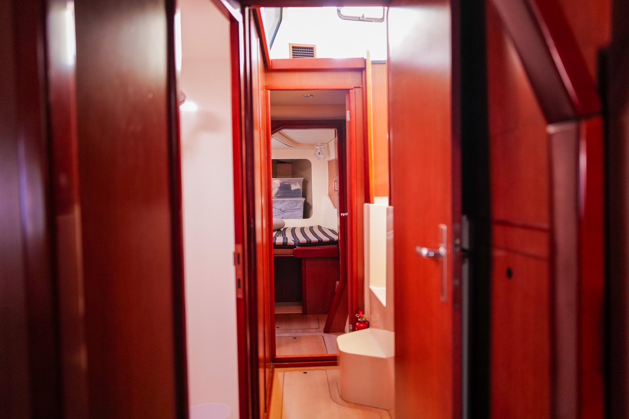 Interior view of a 2012 Leopard 44 yacht, featuring polished wood finishes and cozy cabin space.