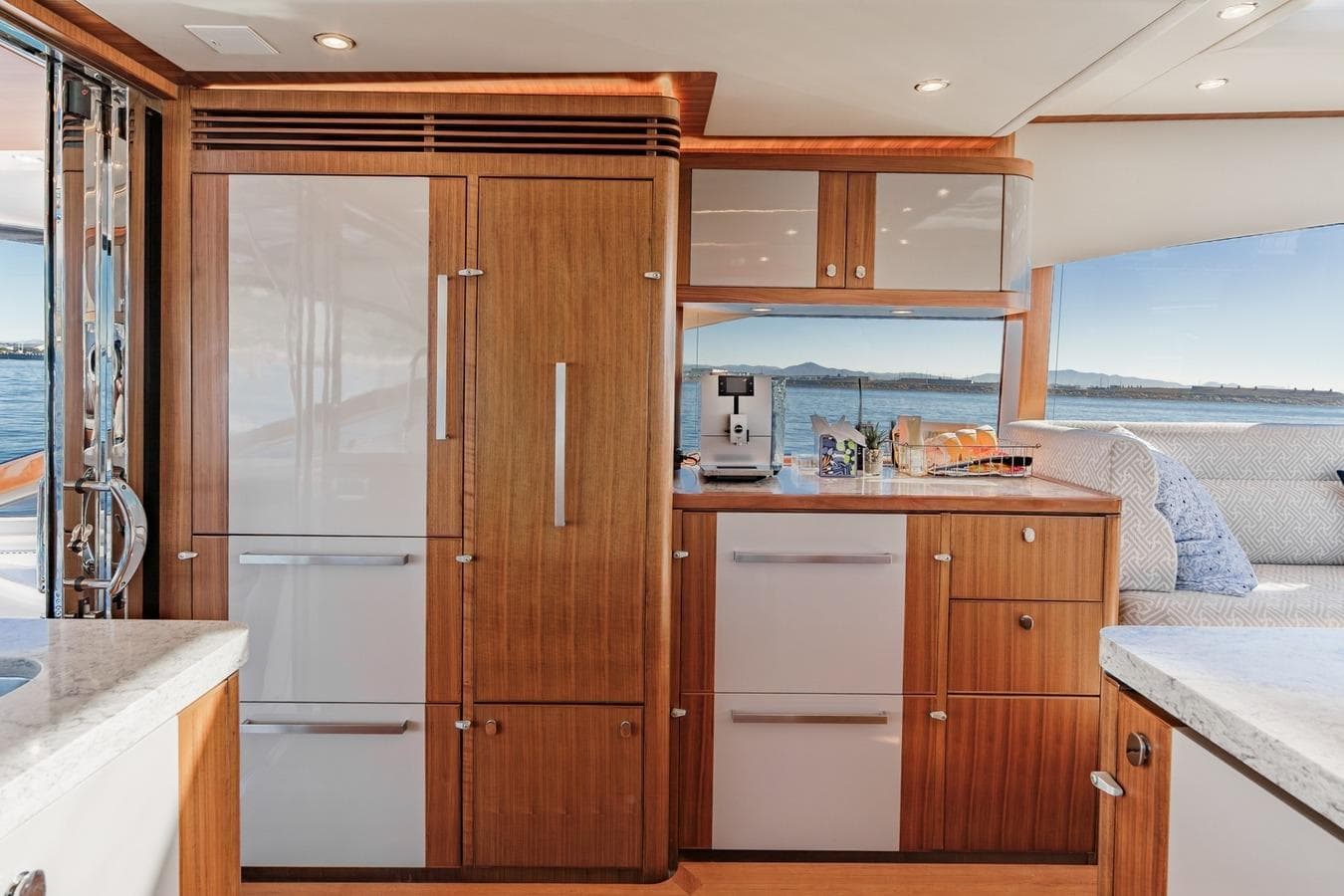 Luxurious interior of 2019 Belize 66 Sedan yacht with modern kitchen and ocean view.