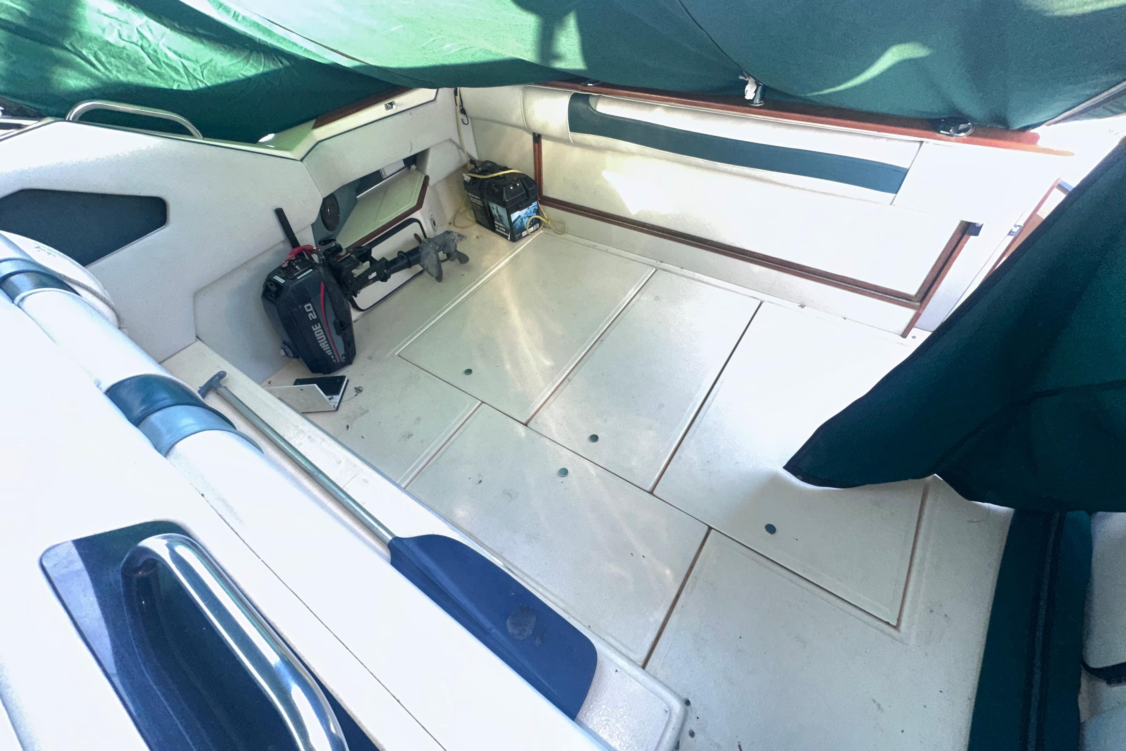 1987 Sea Ray 300 Sundancer interior with green canopy, showing spacious deck and equipment.