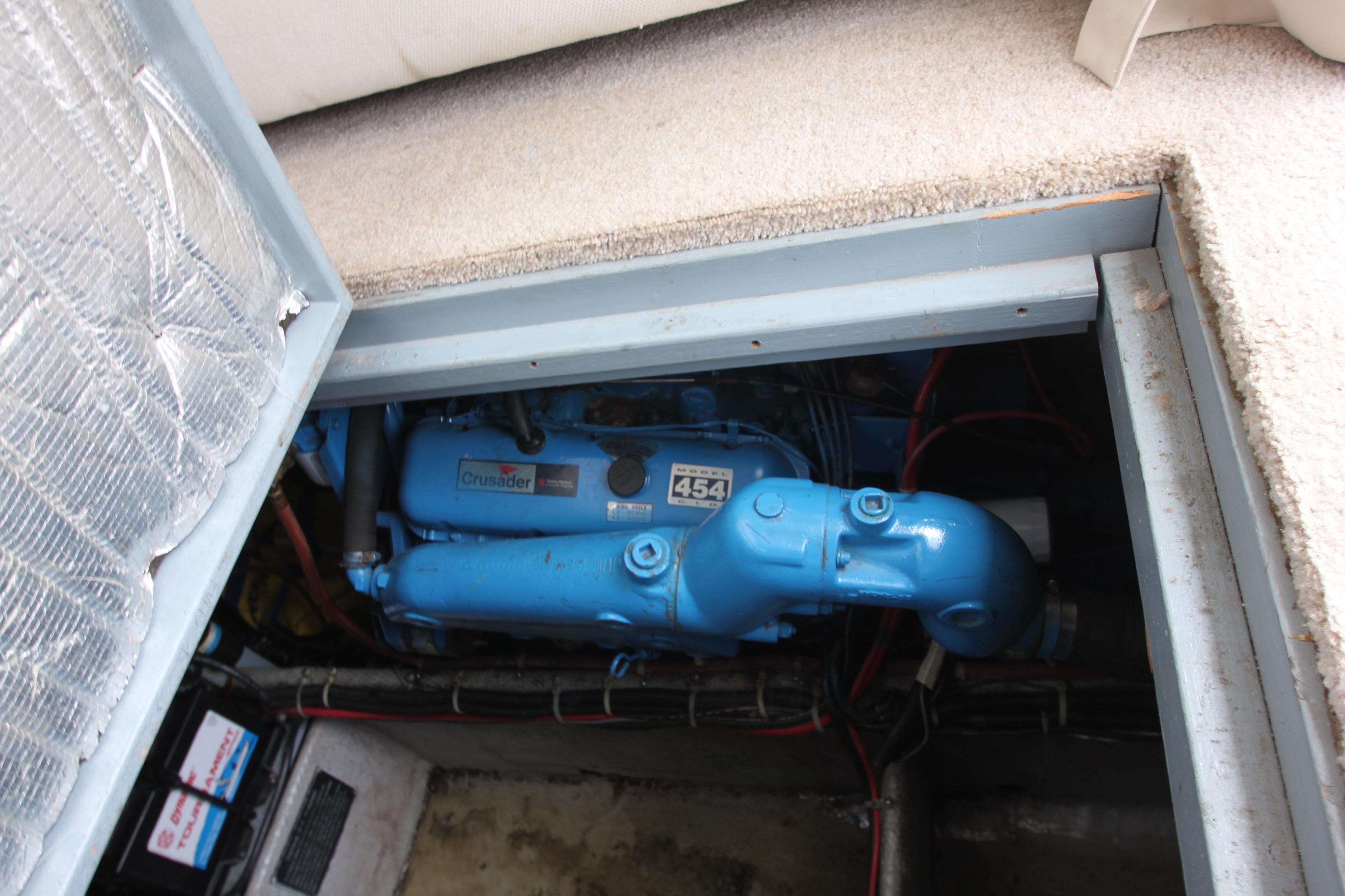 Engine compartment of 1990 Silverton 34 Convertible boat, featuring a blue marine engine.