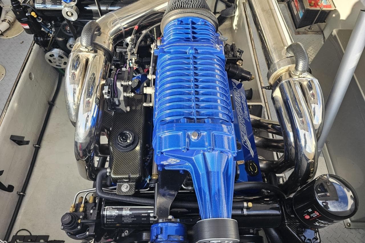 Engine of a 2008 Donzi 38 ZR boat with blue and chrome components.