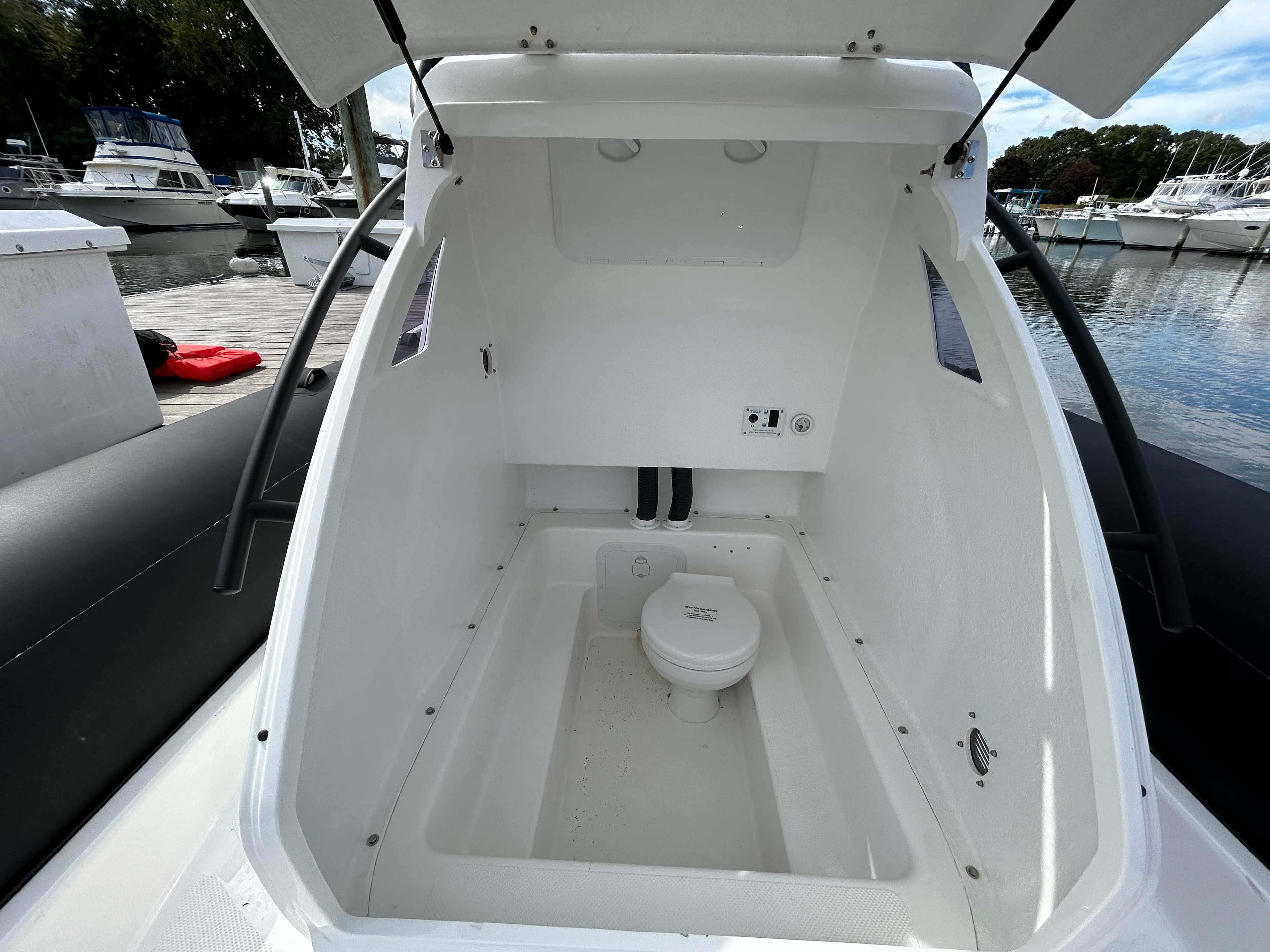 2025 Grand Inflatables G850 boat interior with open hatch and visible toilet.
