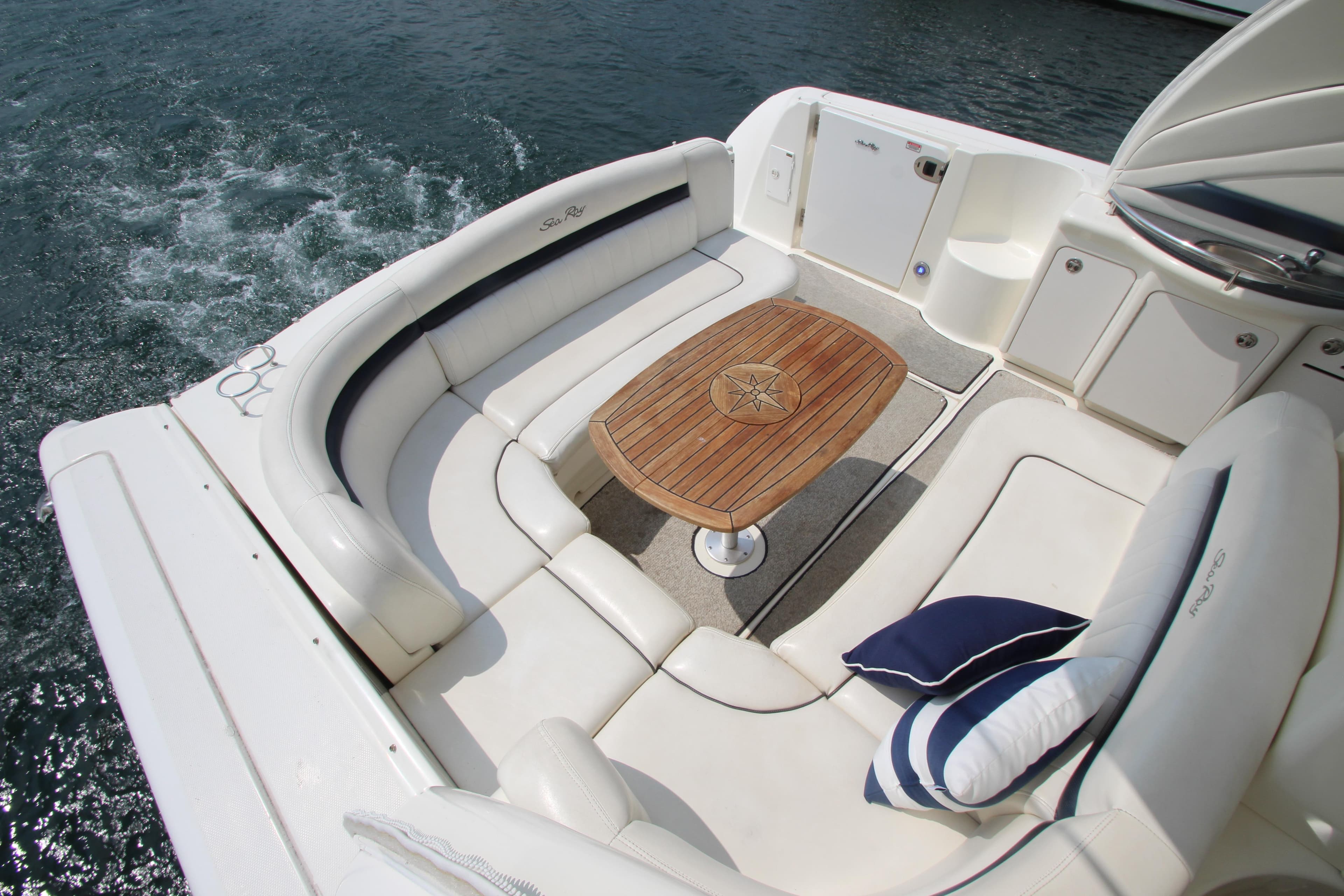 Luxurious 2004 Sea Ray 40 Sundancer yacht with elegant seating and wooden table.