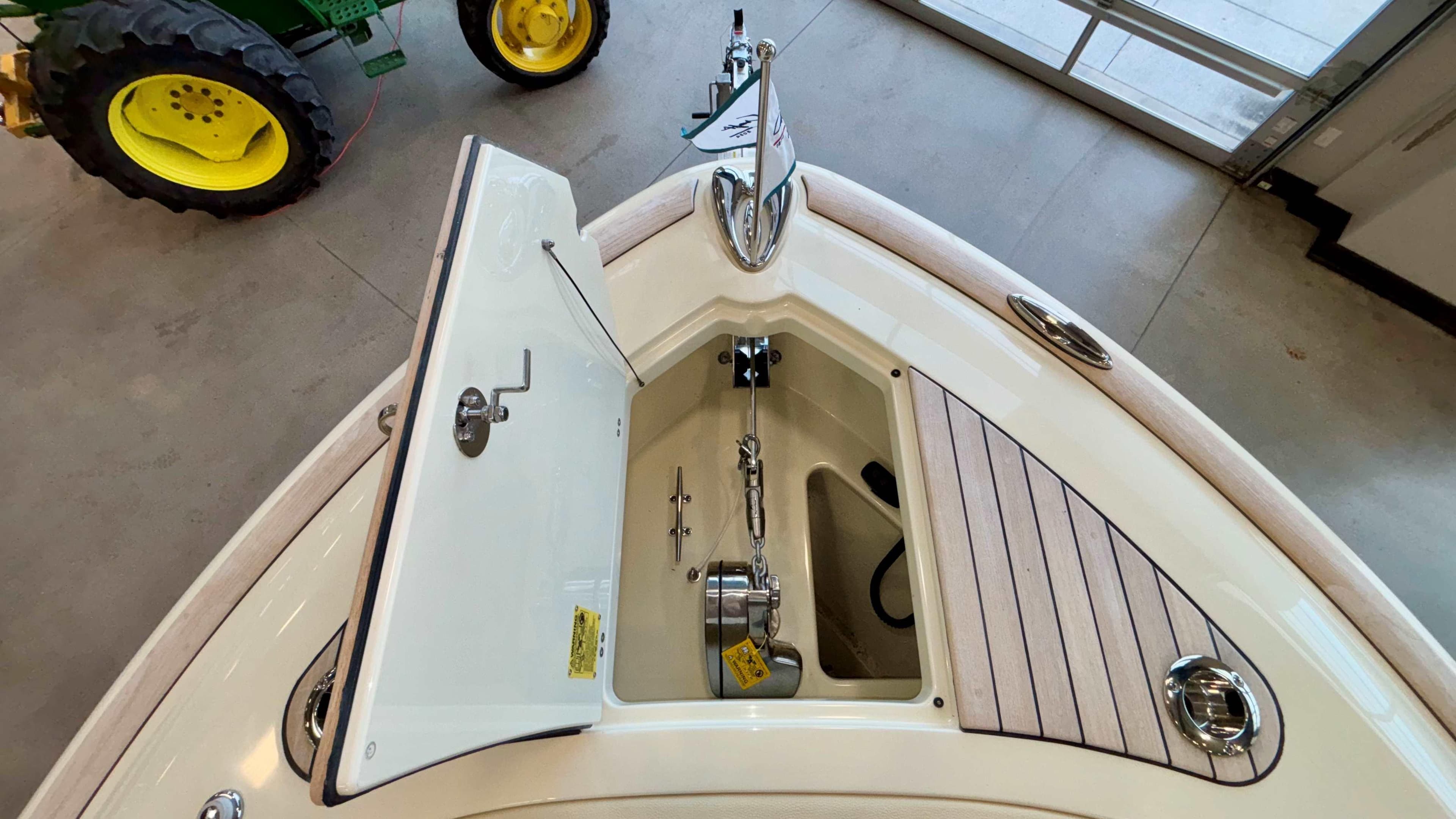 2024 Chris-Craft Calypso 32 CT boat anchor compartment, open lid, indoor display.