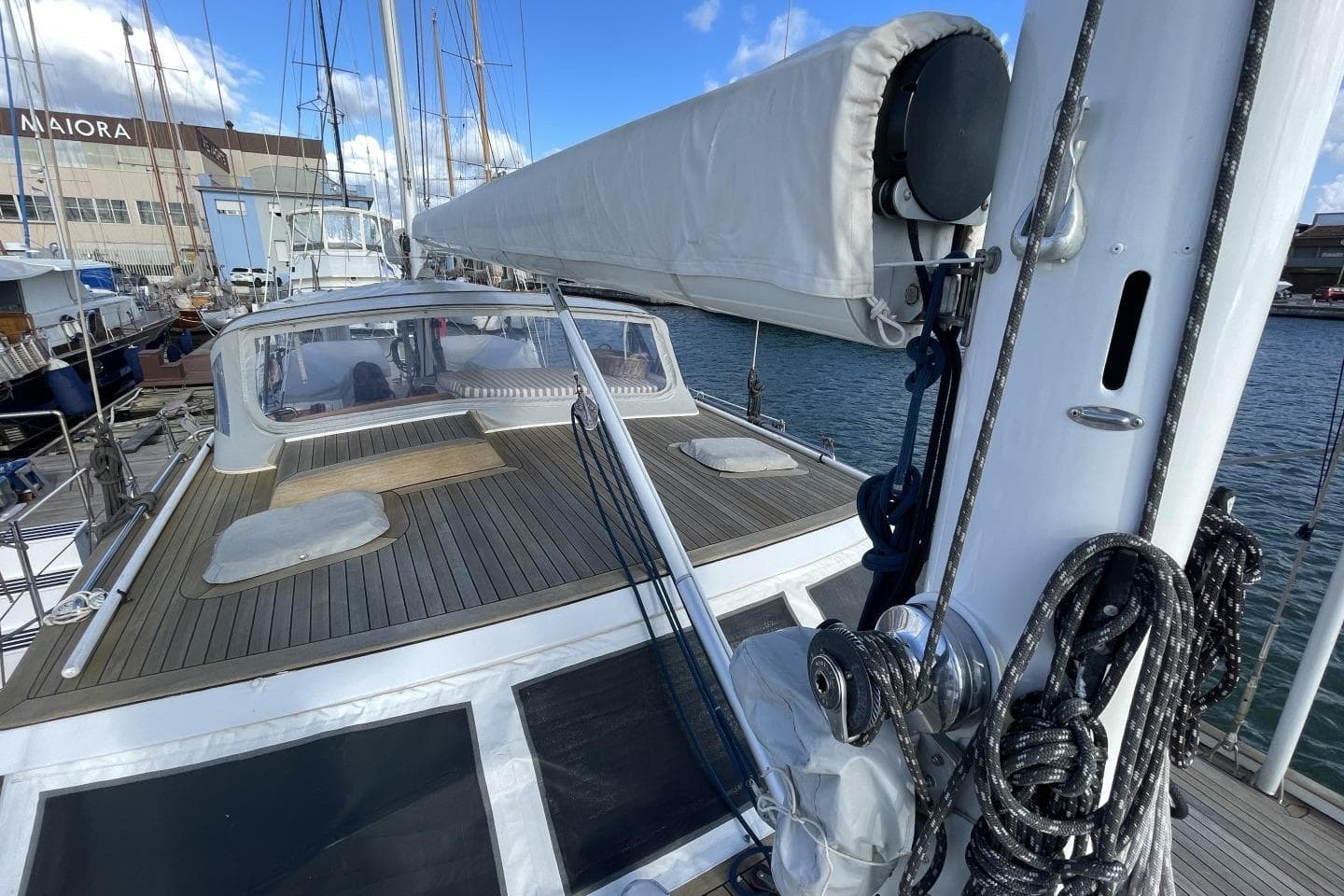 1982 Benetti Sail Division 16m Motorsailer docked, showcasing deck and rigging.