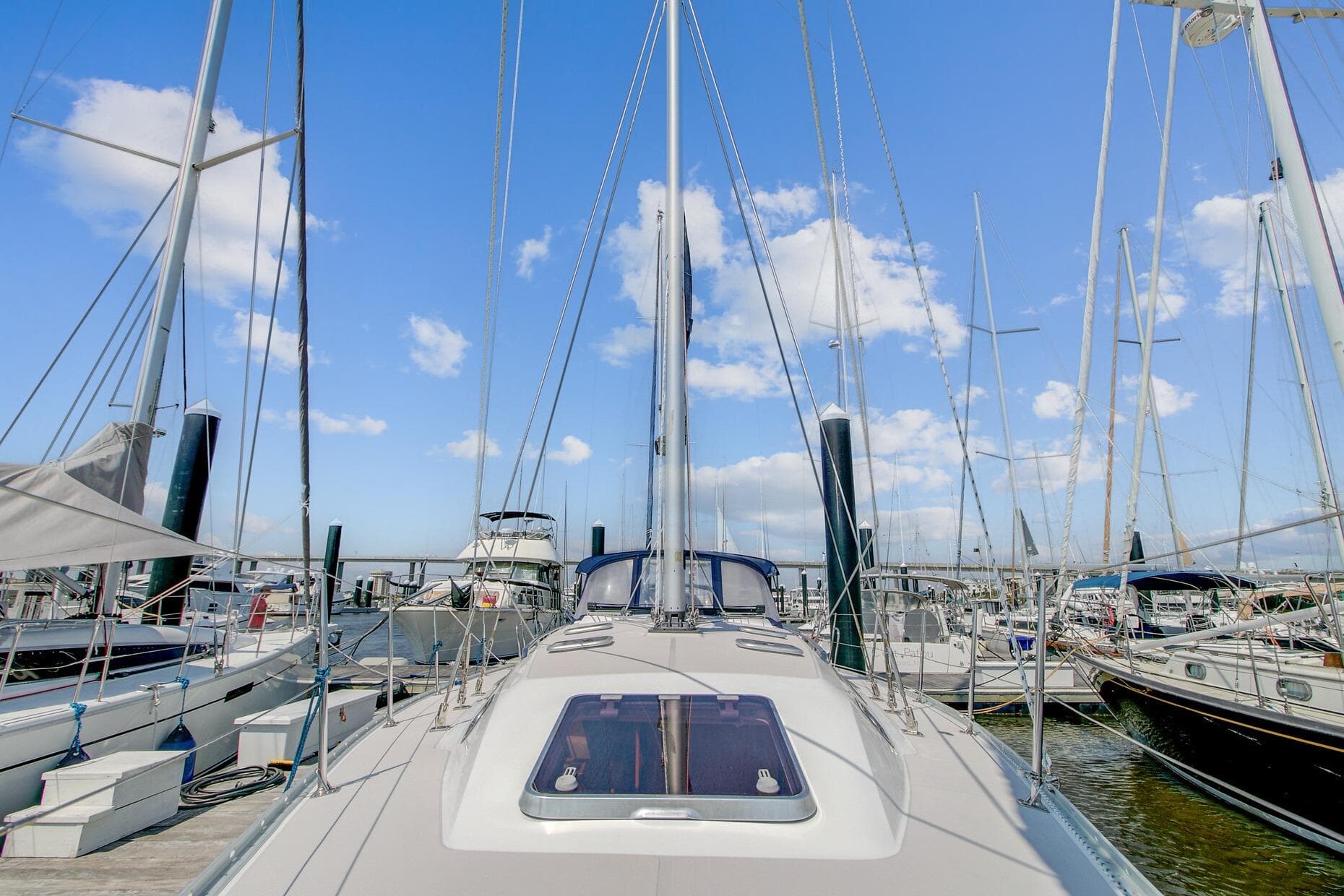 2011 Catalina 445 sailboat docked at marina under clear blue sky.
