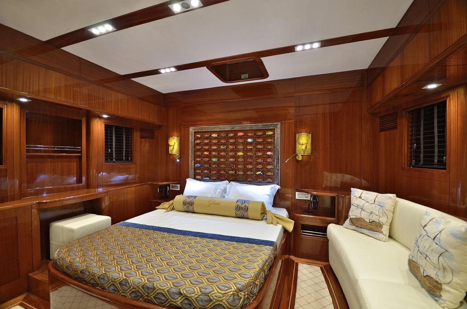 Luxurious cabin interior of 2012 Custom Motorsailor with wood paneling and elegant bedding.