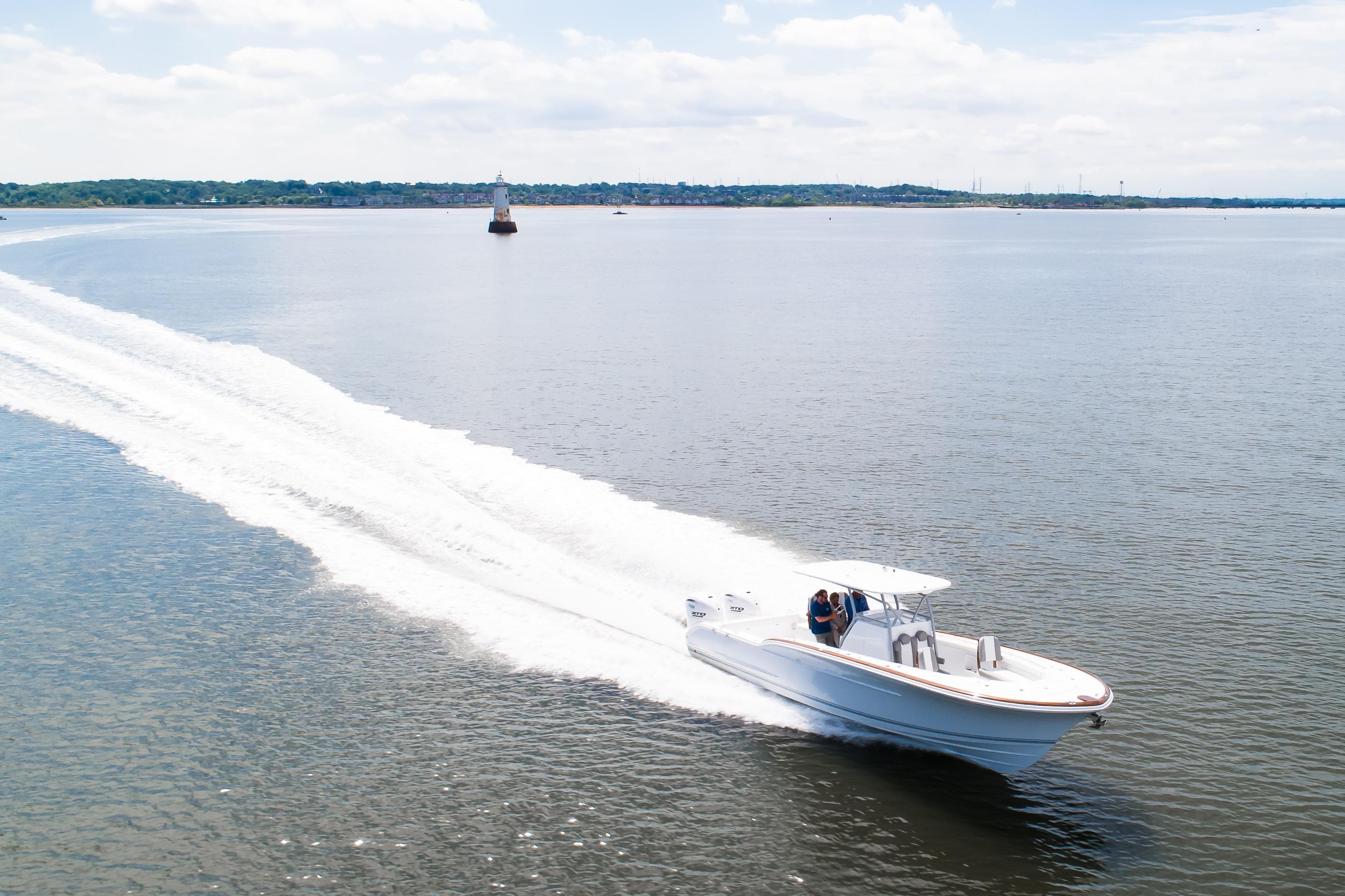 2019 Buddy Davis 34 Center Console boat cruising on open water, leaving a wake.