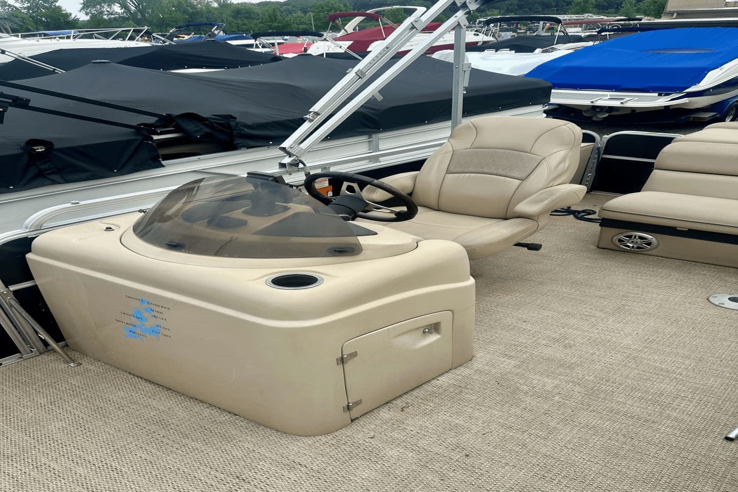 2015 South Bay 524 CR pontoon boat interior with beige seating and helm.