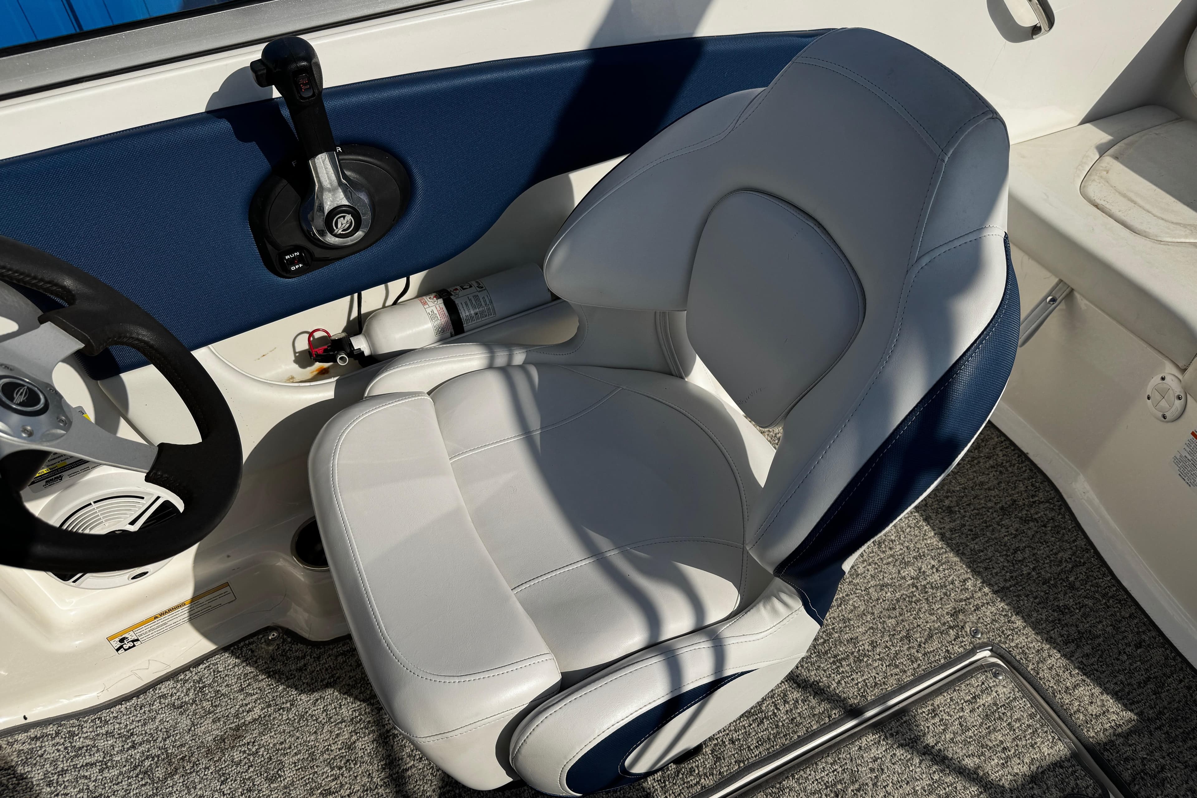 2015 Chaparral 19 H2O Sport boat interior with steering wheel and captain's seat.