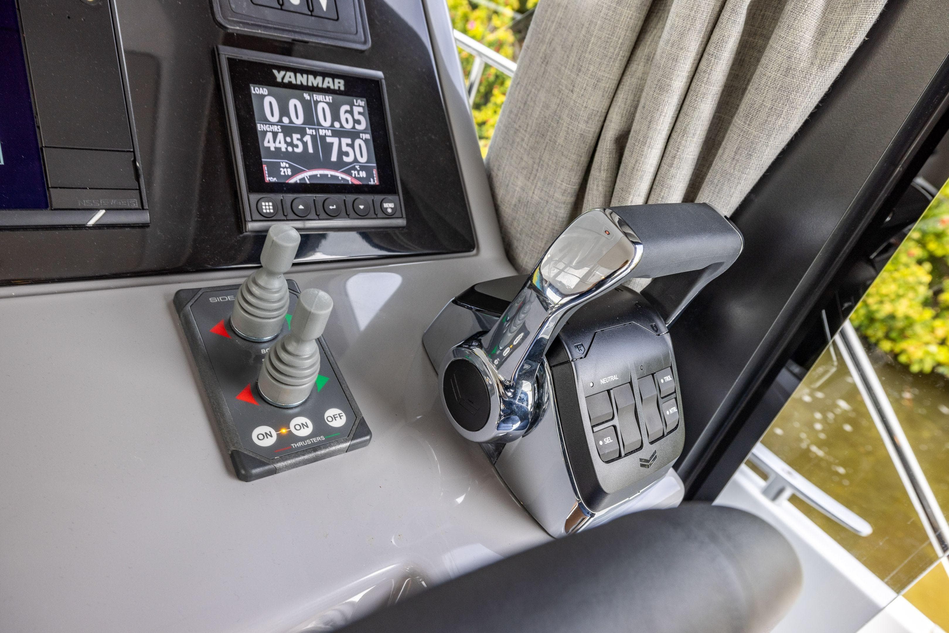 Control panel of 2026 Delphia D11 Flybridge with Yanmar display and throttle levers.