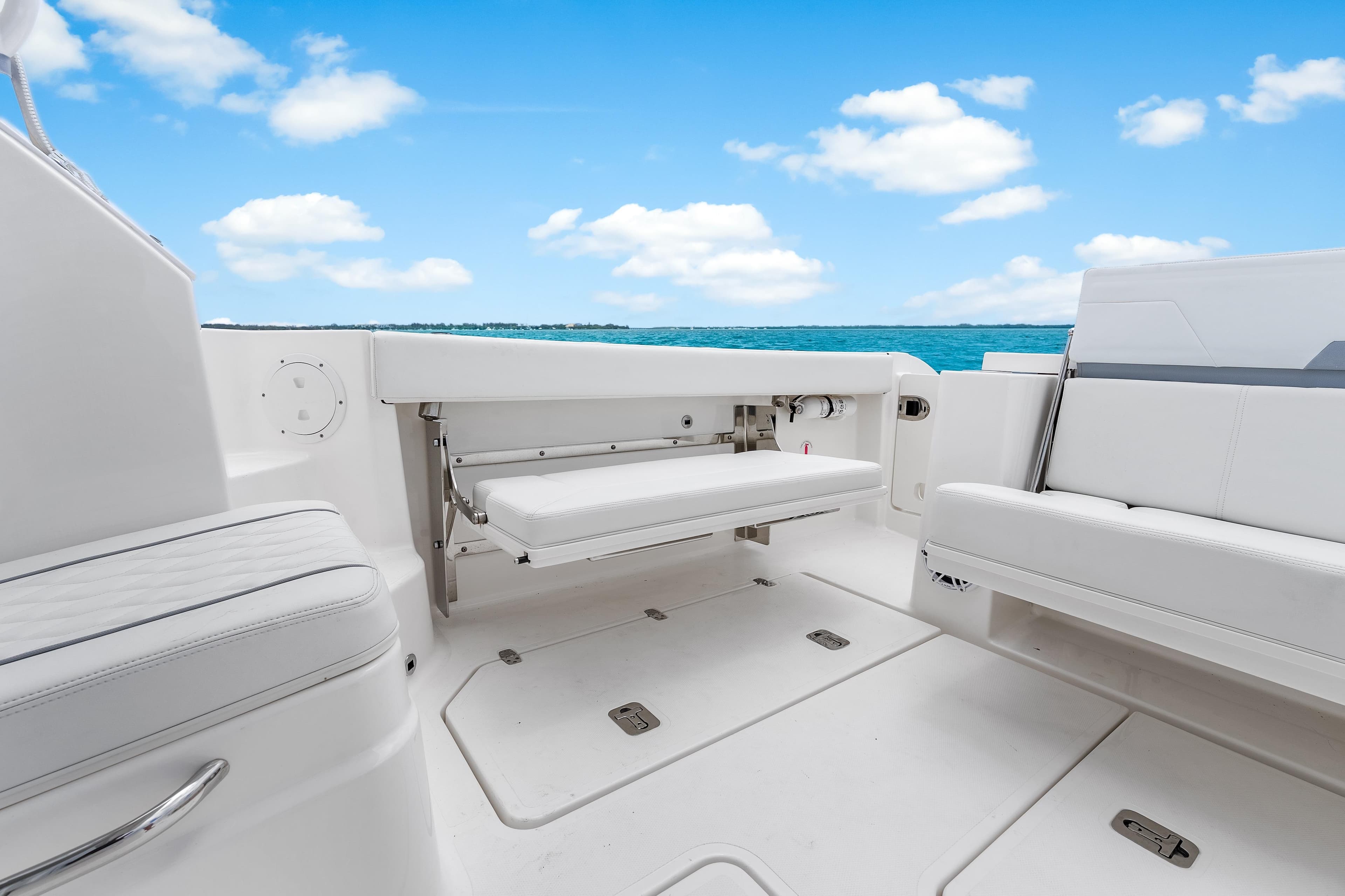 2026 Pursuit OS 405 Offshore boat interior with white seating and ocean view.