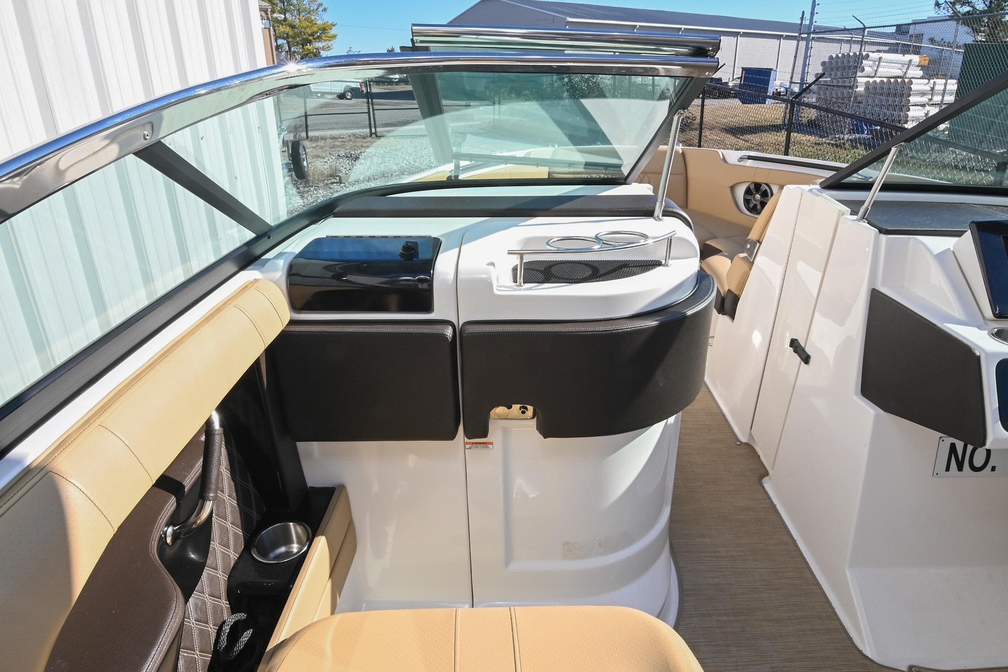 2020 Sea Ray SLX 250 boat interior with beige seating and modern dashboard.