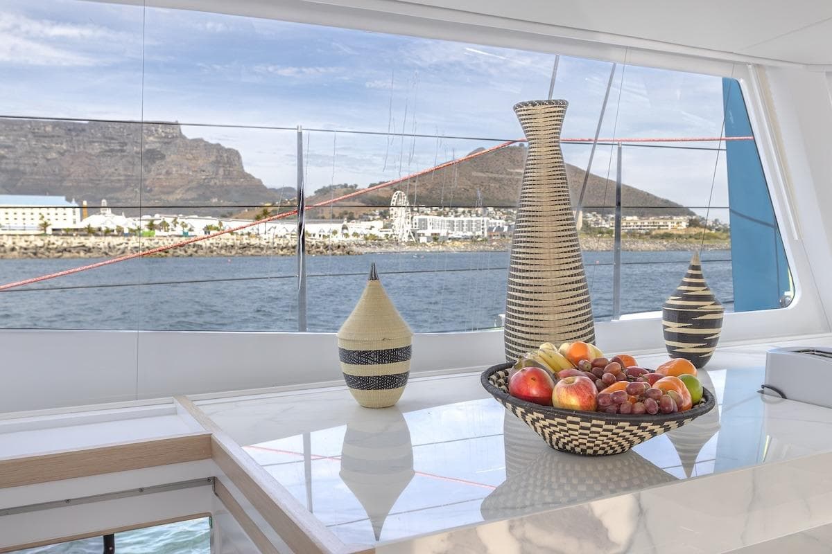Luxurious Balance 580 yacht interior with fruit basket and scenic ocean view, 2027 model.
