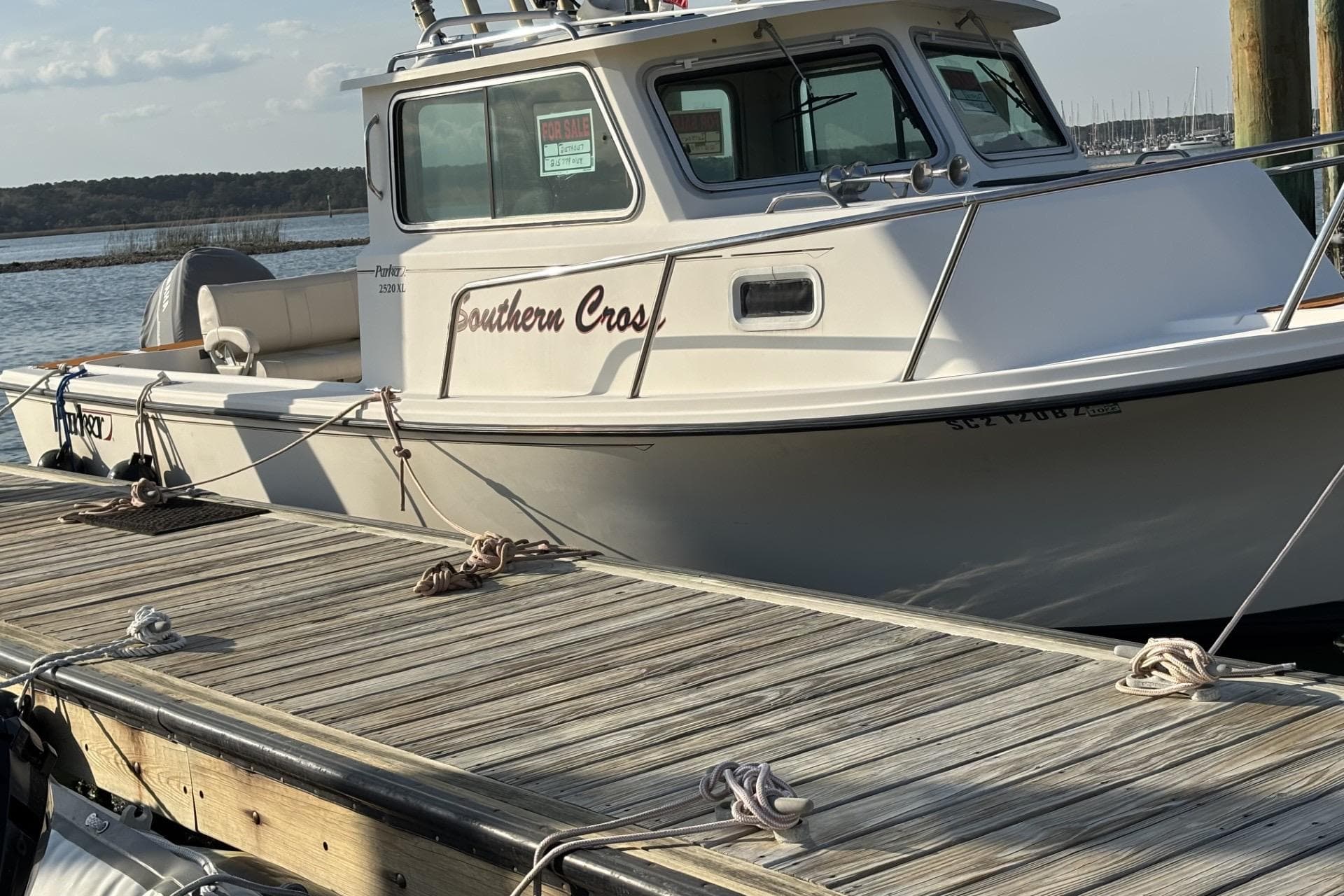 2006 Parker 2520 XL Sport Cabin boat docked, "Southern Cross" name visible, for sale sign displayed.