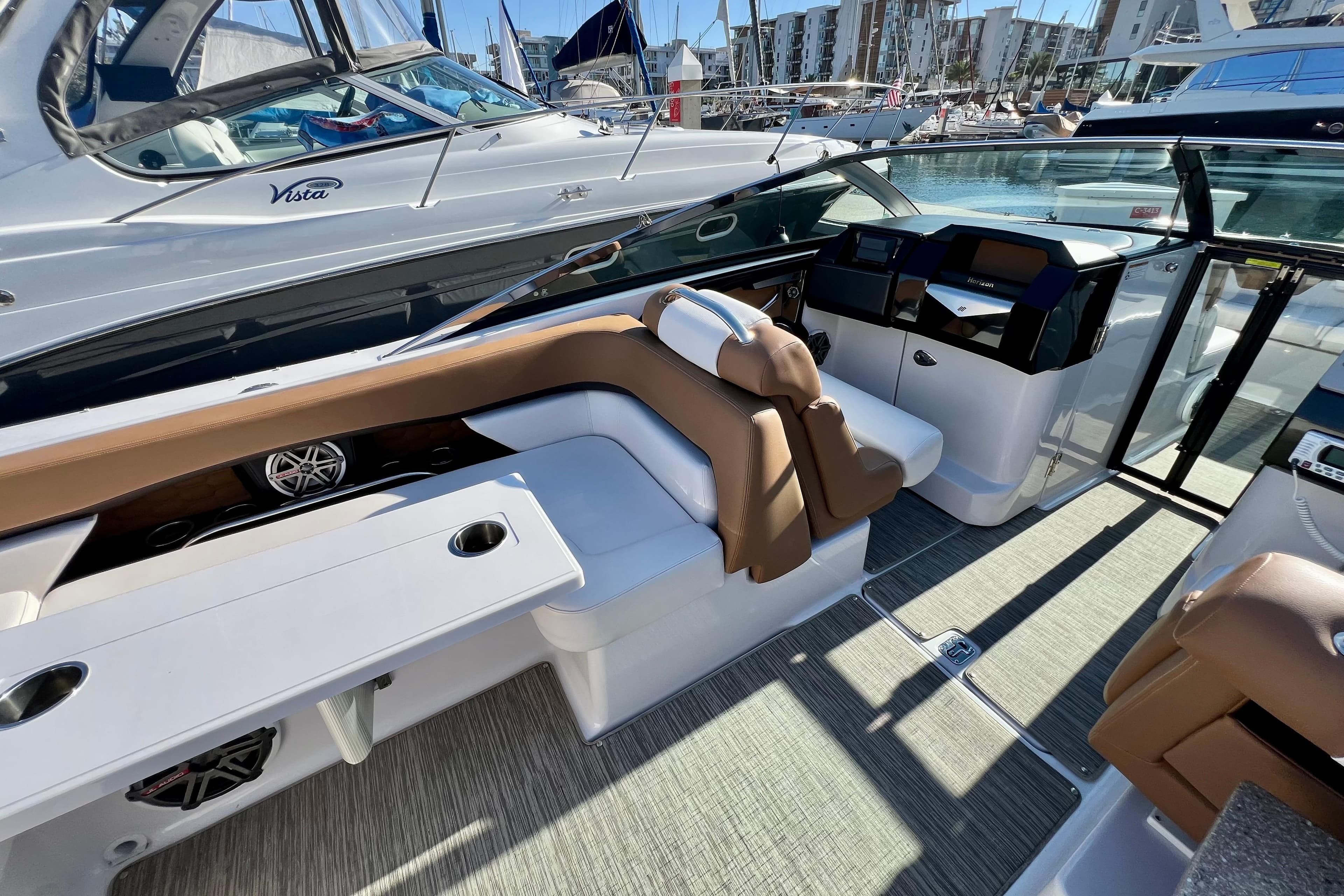 2019 Four Winns Horizon H290 boat interior with seating and control panel.