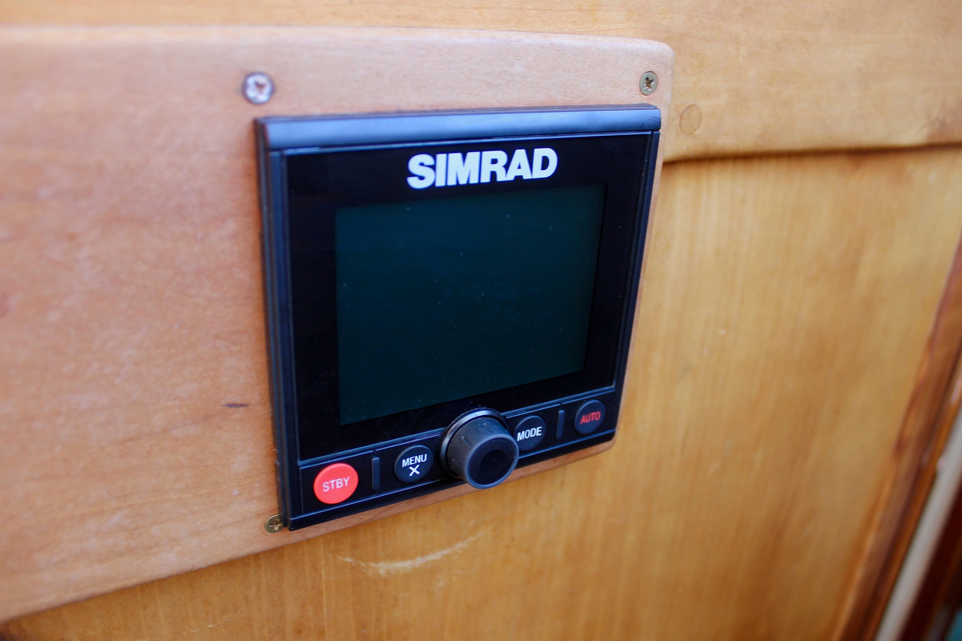 Simrad control panel on 1997 Valiant 39 boat, mounted on wooden surface.
