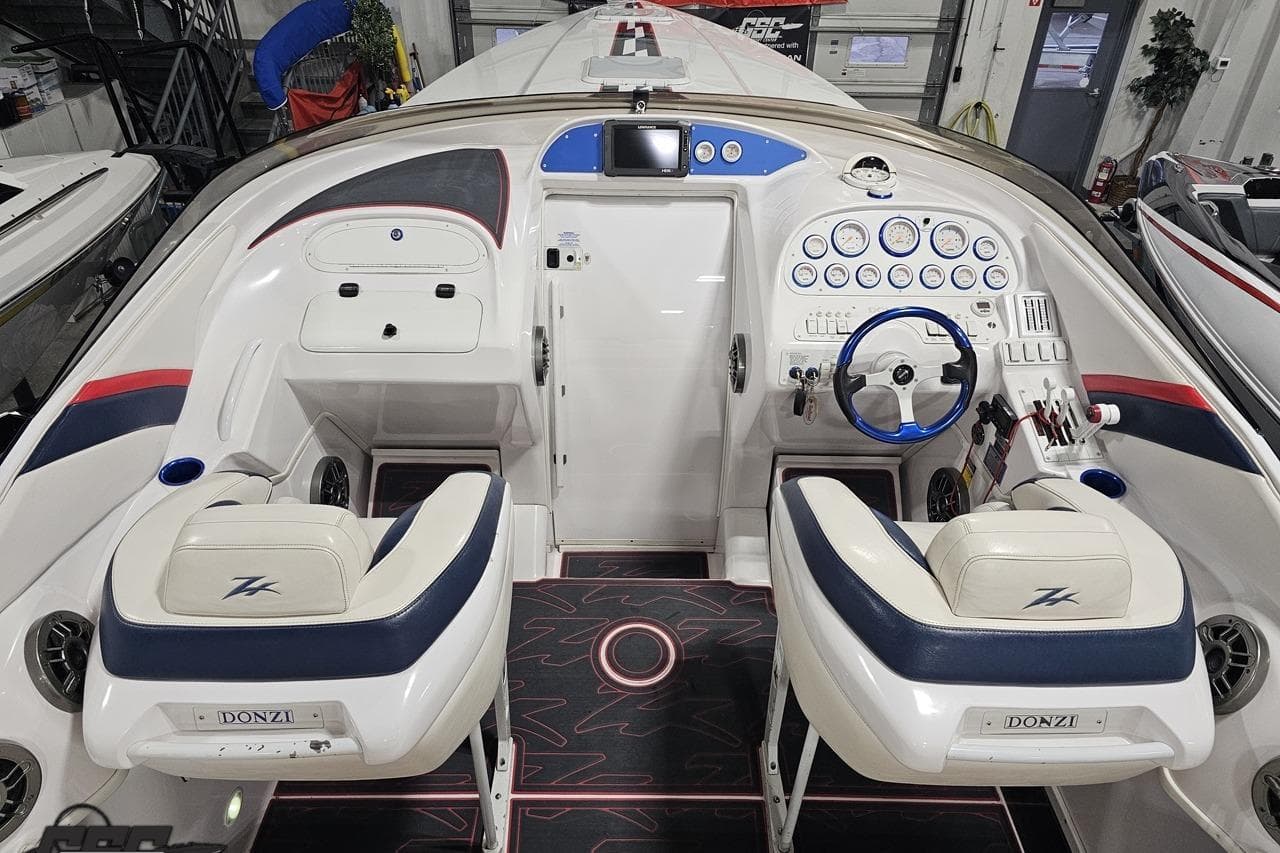 2000 Donzi 33 ZX boat cockpit with dual seats, steering wheel, and control panel.