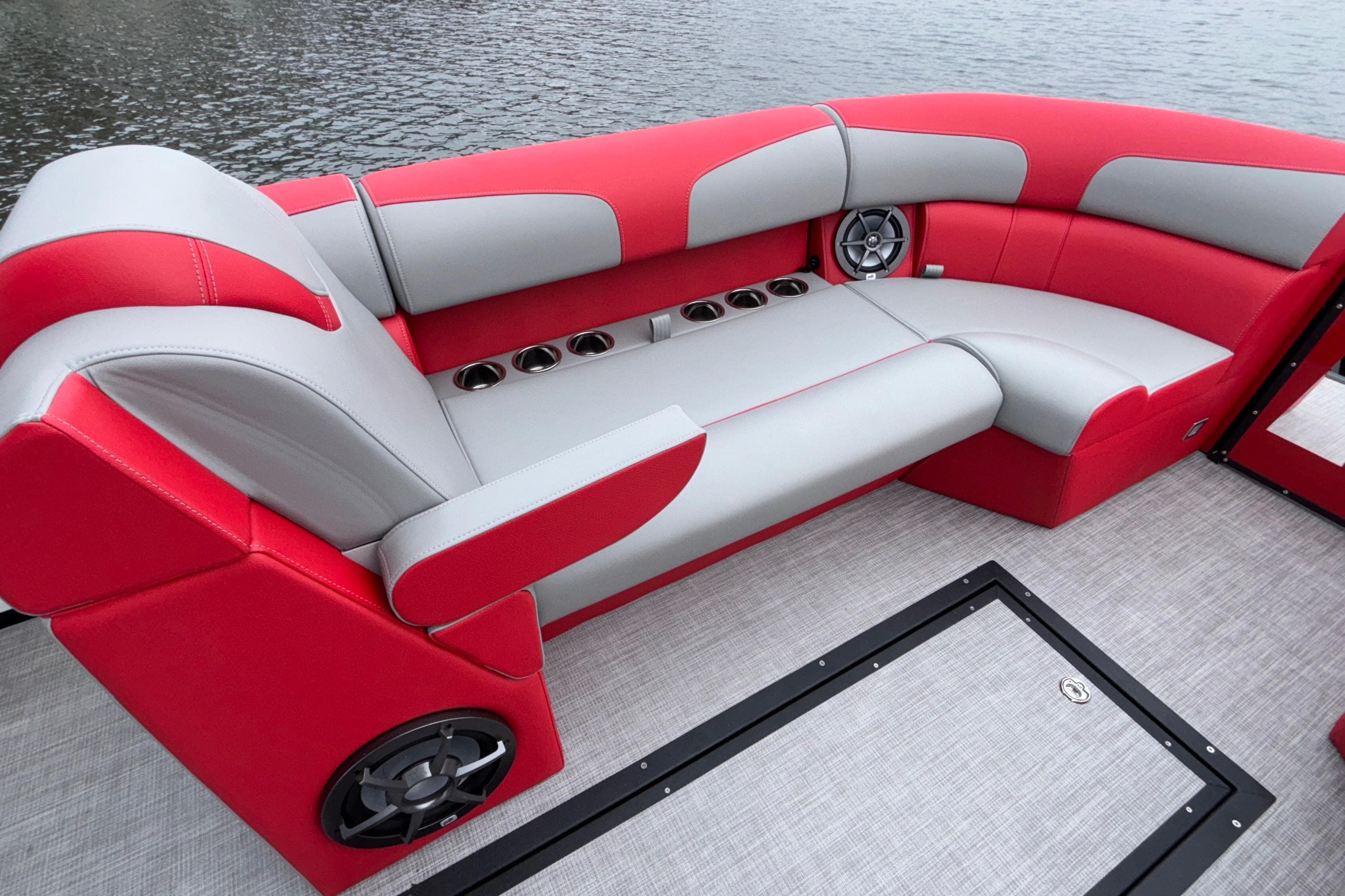 2025 Montara 25 Surf Boss boat interior with red and gray seating, cup holders, and speakers.