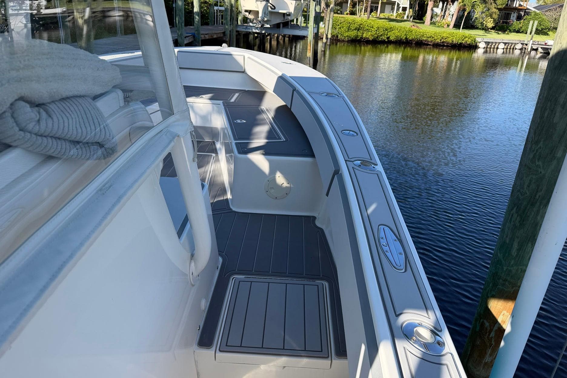 2002 Regulator 26 Center Console boat docked by calm waters.
