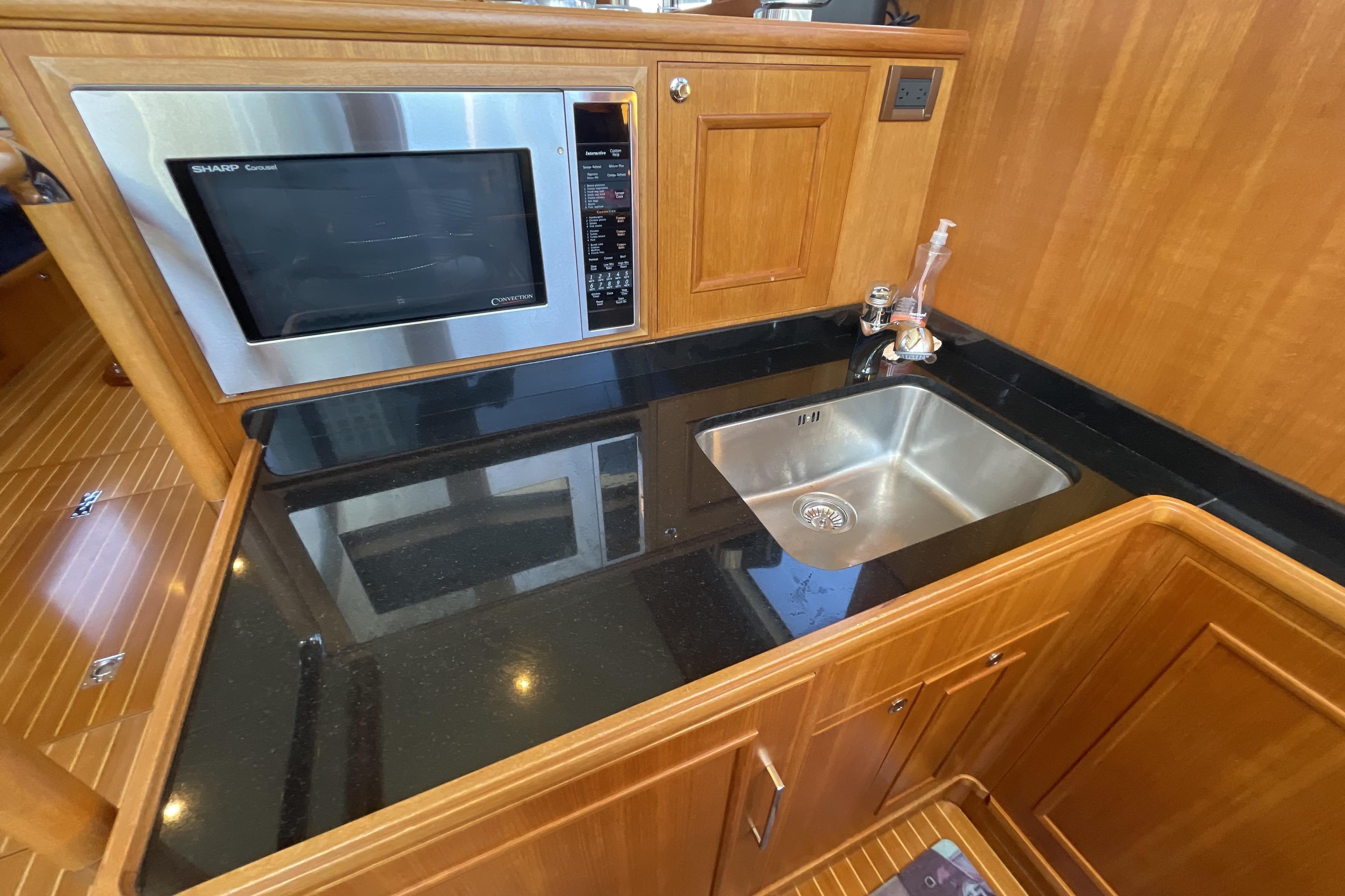 Galley of 2007 Grand Banks 47 Heritage CL with microwave and sink.