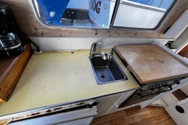 1978 Bruno & Stillman boat kitchen with sink, cutting board, and coffee maker.
