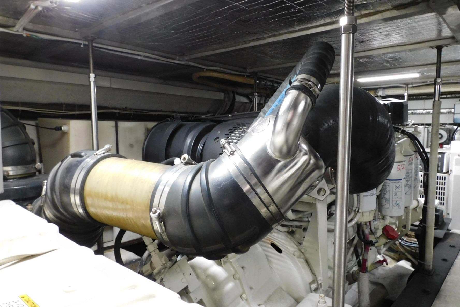 Engine room of 2002 Carver 570 Voyager Pilothouse with visible exhaust system.