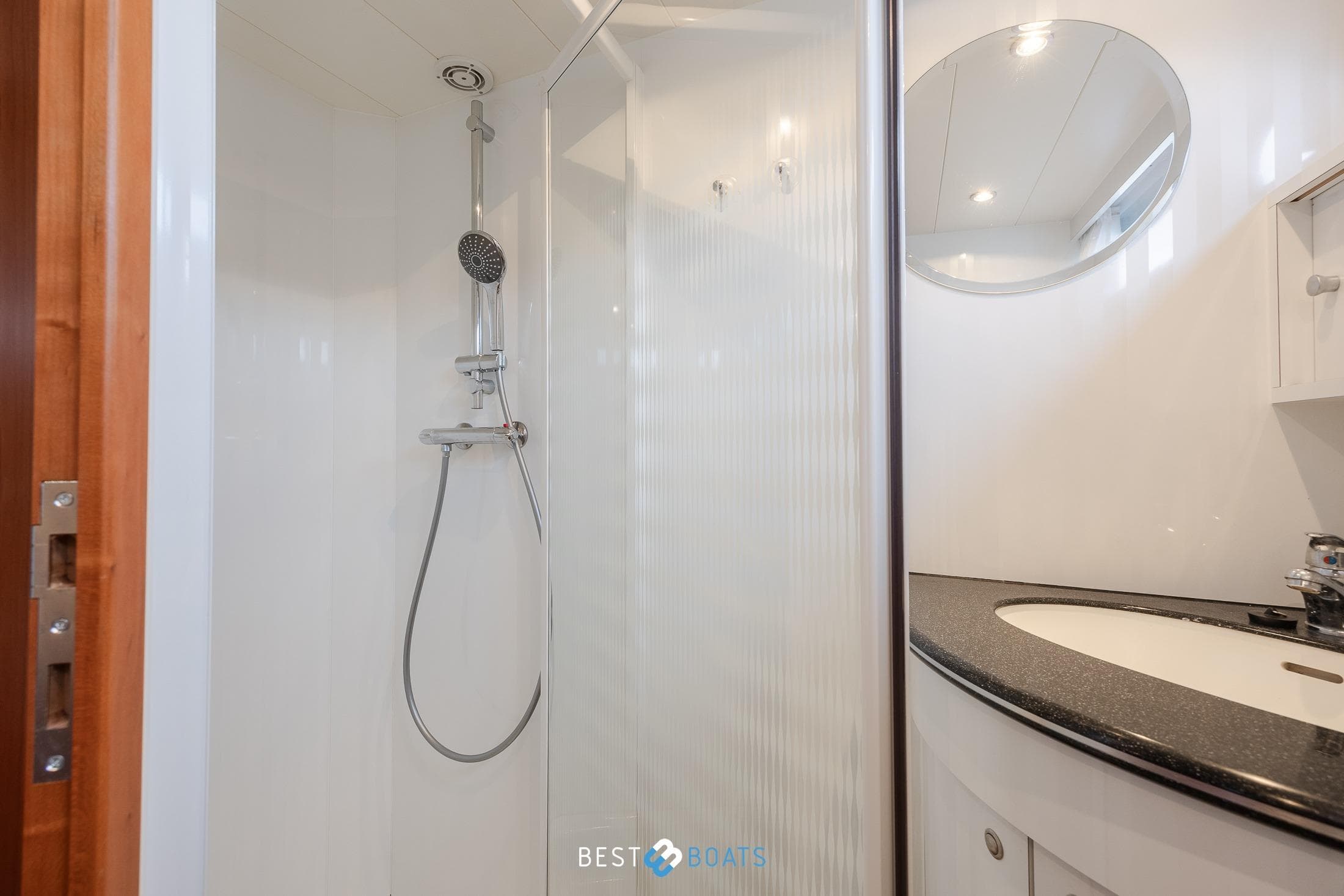 Modern bathroom with shower and sink on 2008 Linskens Catfish 1400 boat.