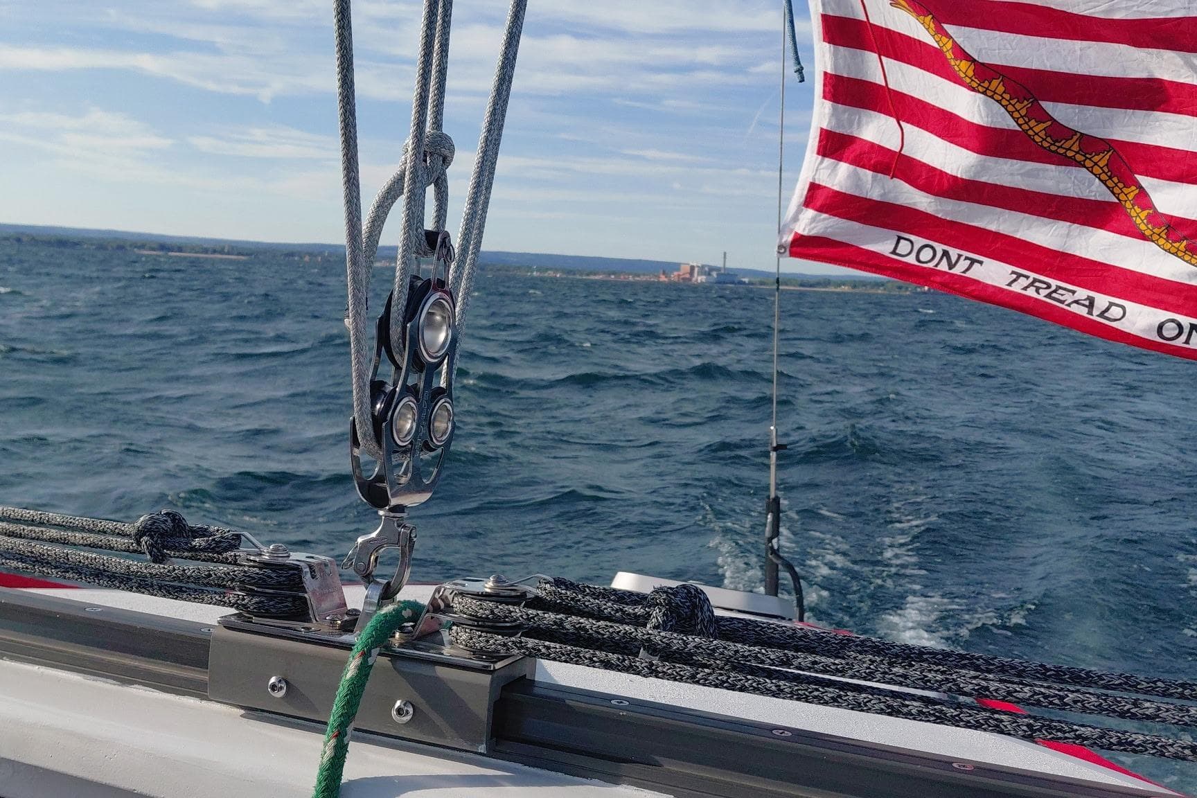 Sailing on a 1979 Newick Native boat with "Don't Tread On Me" flag in the wind.
