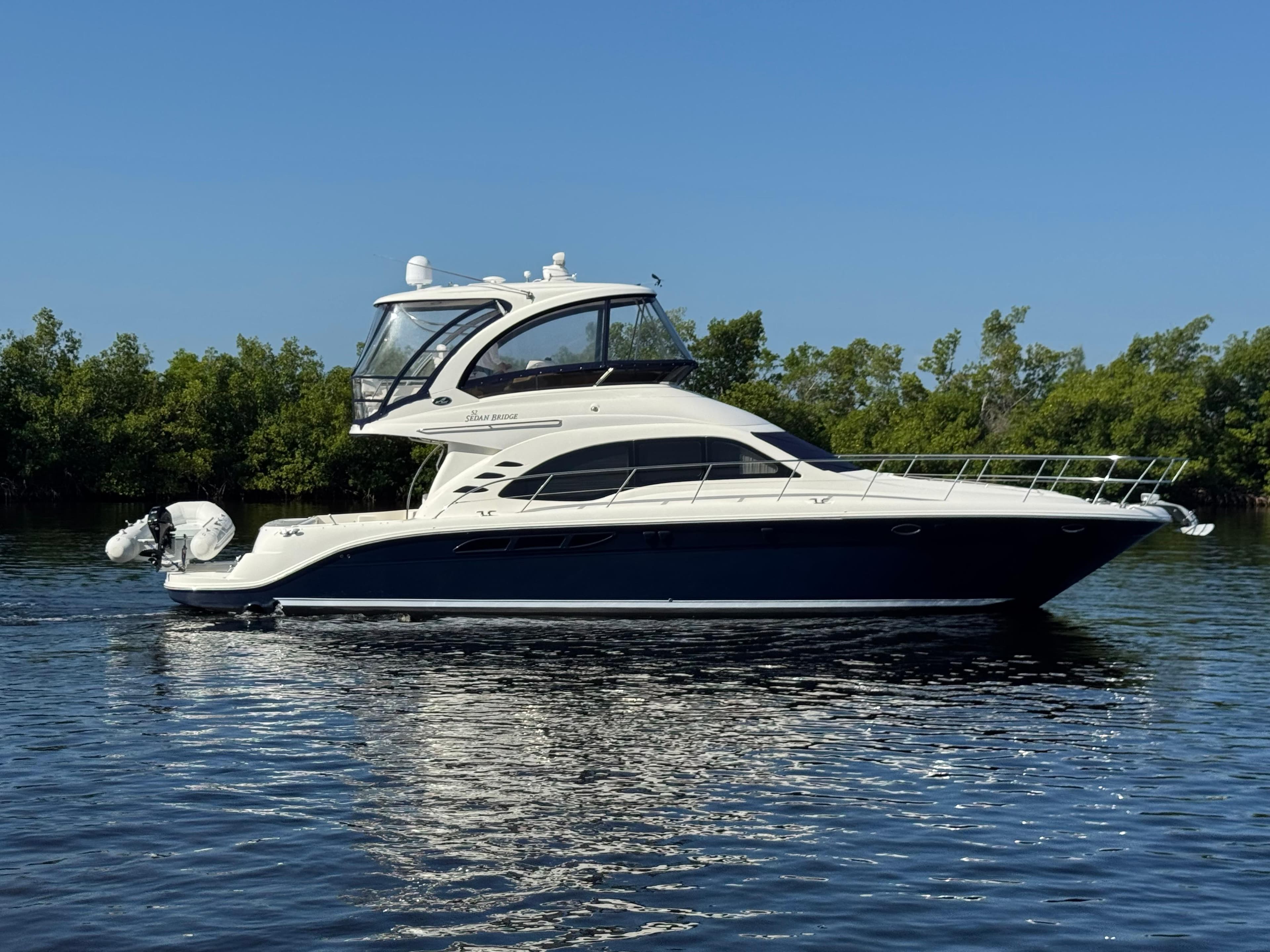 2007 Sea Ray 52 Sedan Bridge yacht cruising on calm water.