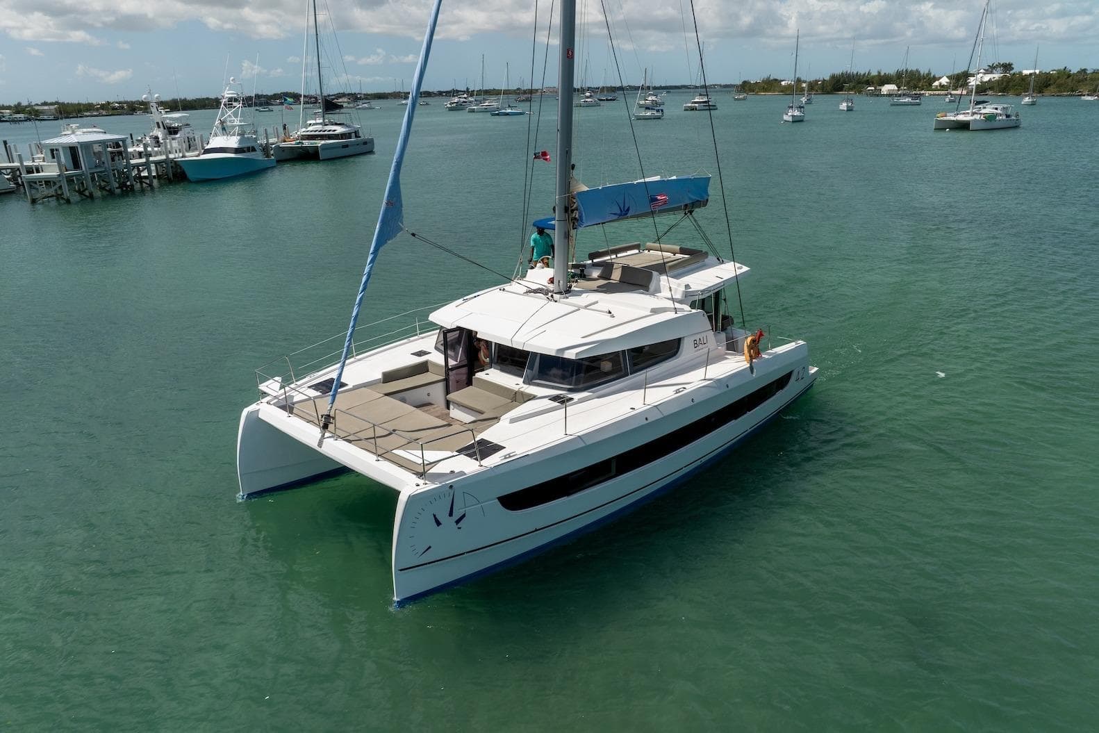 2022 Bali 4.2 catamaran sailing in a serene harbor.