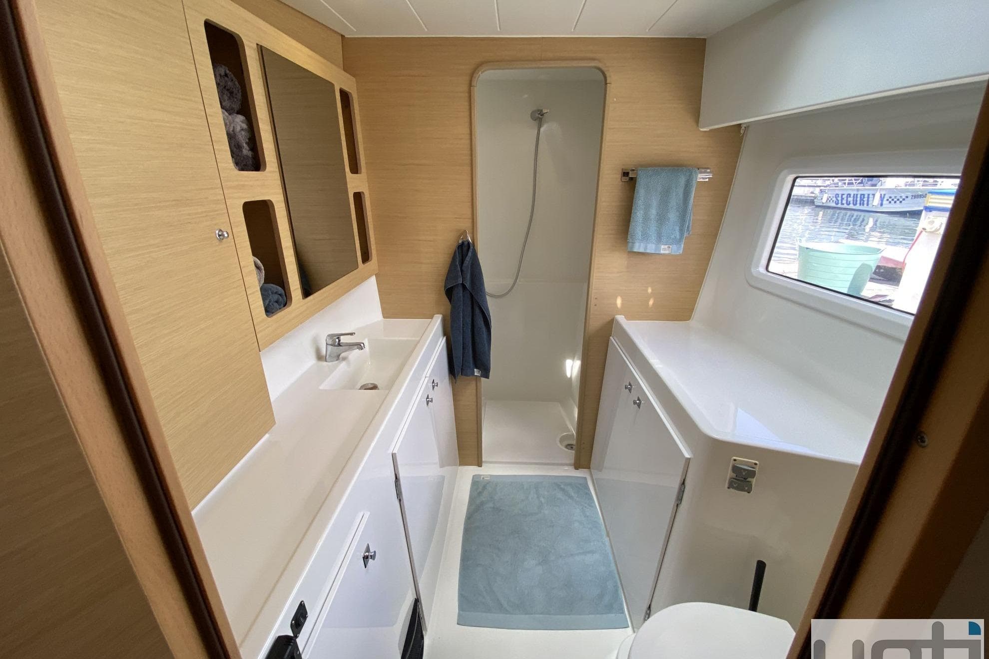 Modern bathroom interior of 2017 Lagoon 42 yacht with shower and sink.