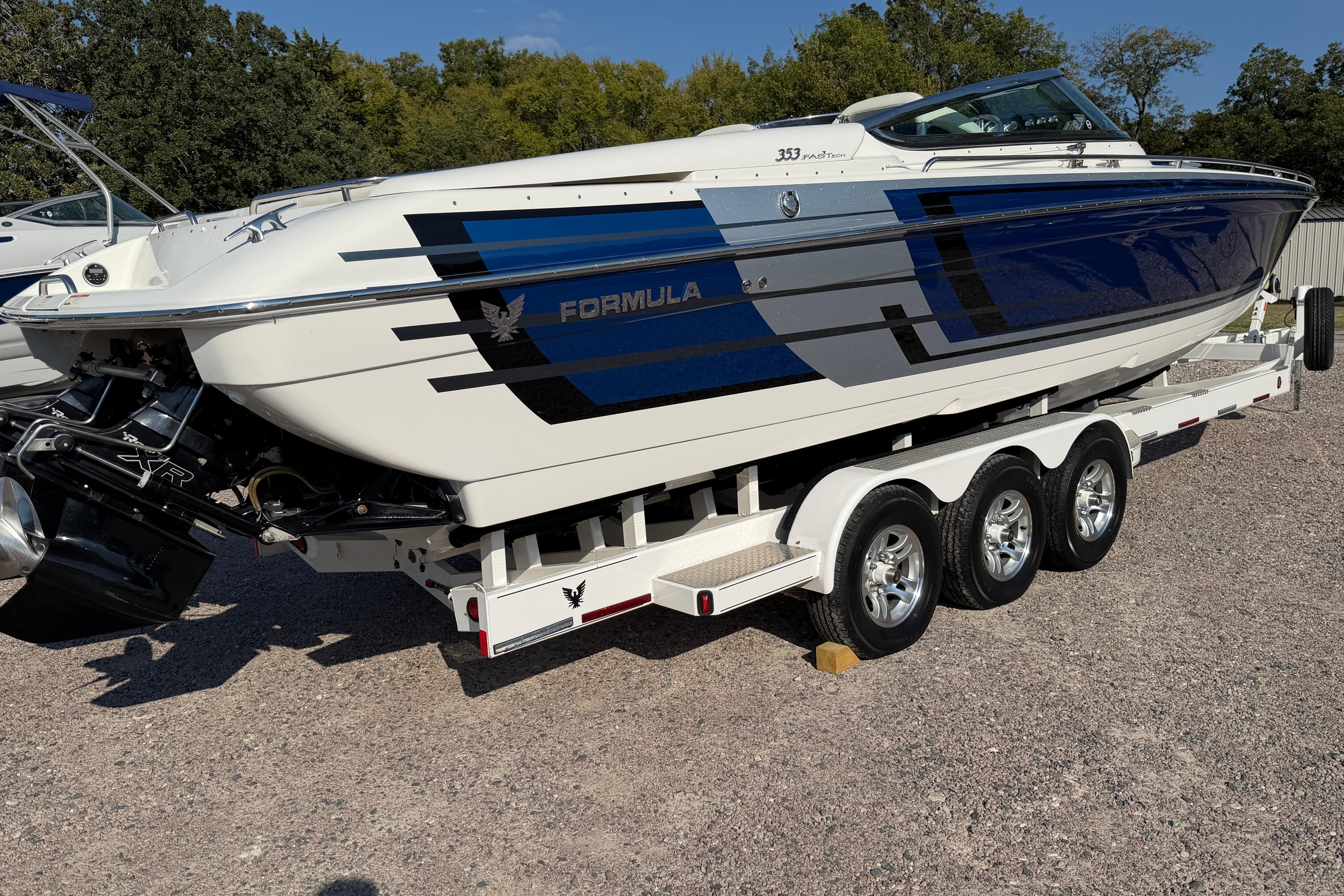 2019 Formula 353 FASTech boat on a triple-axle trailer, parked outdoors.