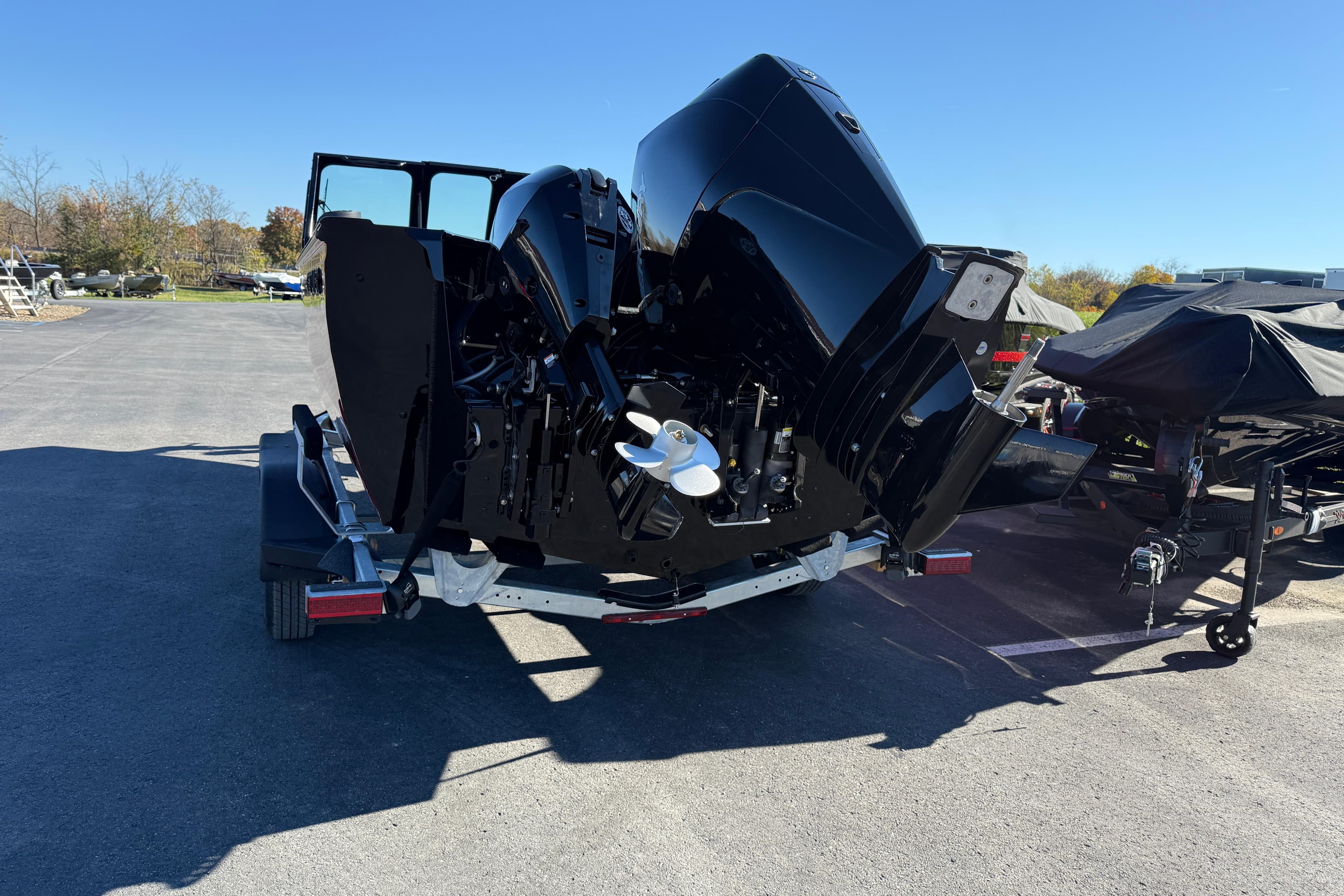 2026 Crestliner 2050 Commander Elite boat on trailer, rear view, sunny day.
