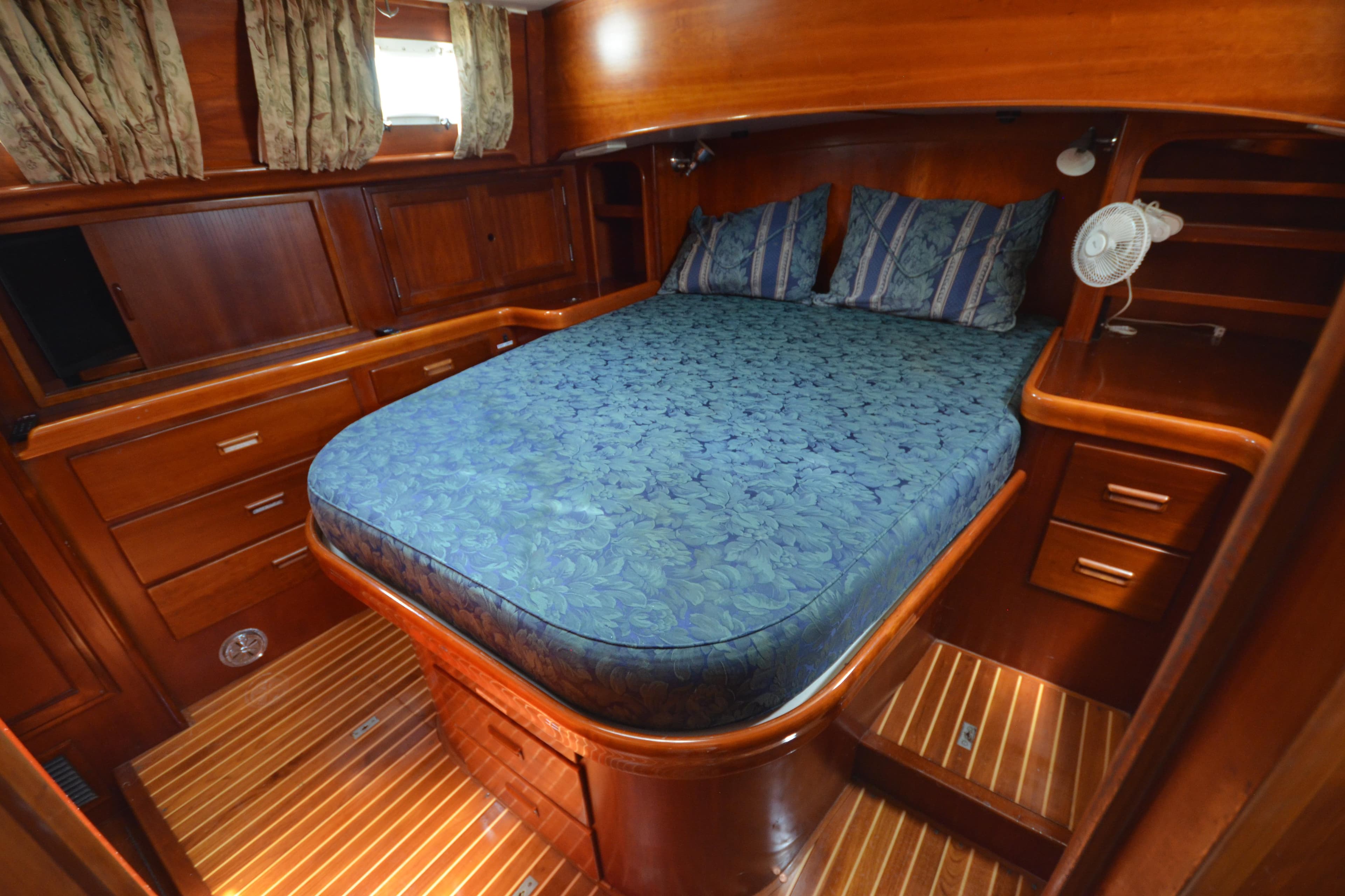 Luxurious cabin interior of 1992 Hinckley Sou'wester 59 yacht with wooden furnishings.