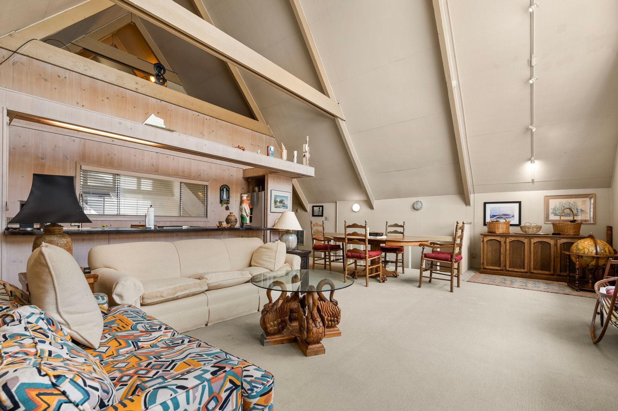 Spacious 1976 custom boathouse interior with cozy seating, dining area, and rustic decor.