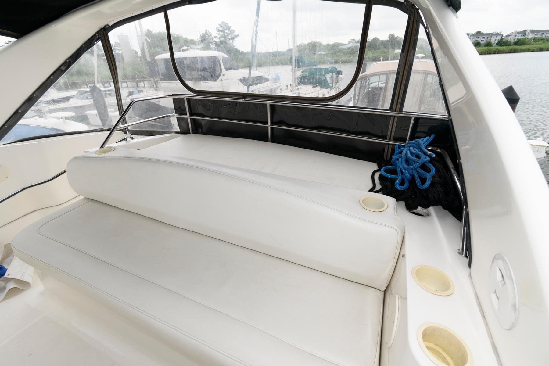 2000 Silverton 330 Sport Bridge boat interior with white seating and cup holders.